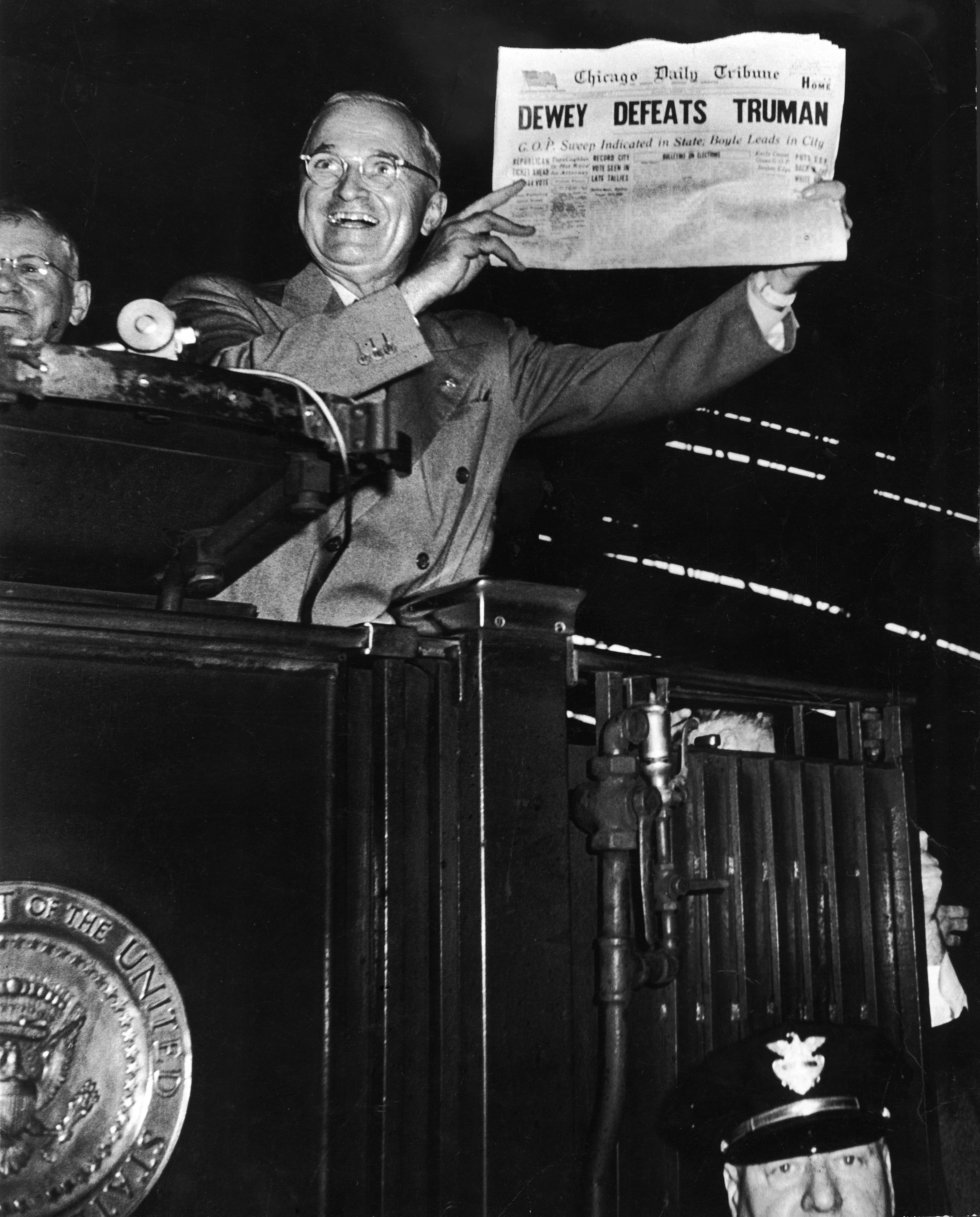 President-elect Harry Truman jubilantly holds up Chicago Daily Tribune newspaper with headlines  DEWEY DEFEATS TRUMAN  which overconfident Republican editors had rushed to print on night of the election.