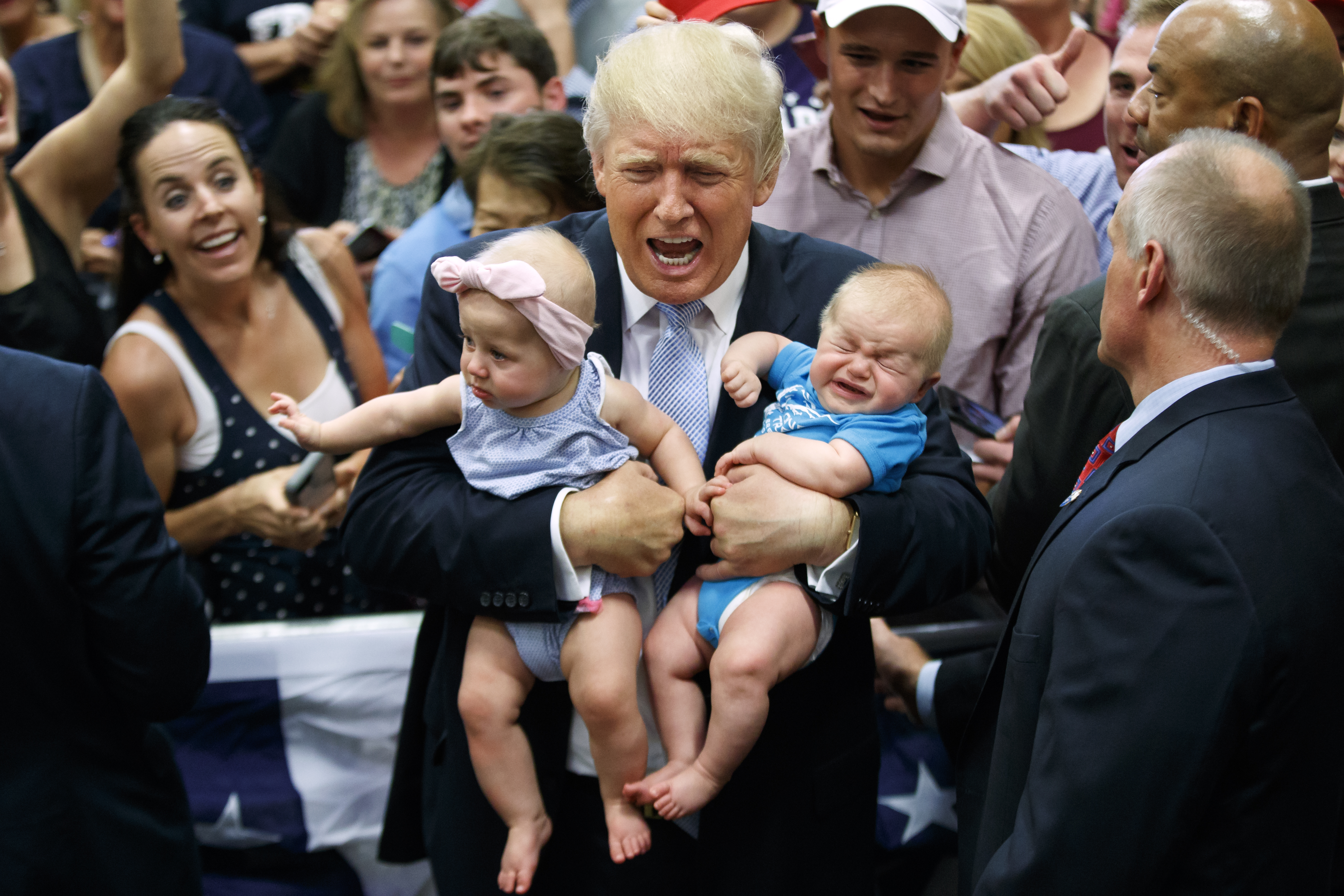 Donald Trump holds Kellen Campbell(R) and Evelyn Keane during a campaign rally in Colorado Springs, on July 29, 2016.