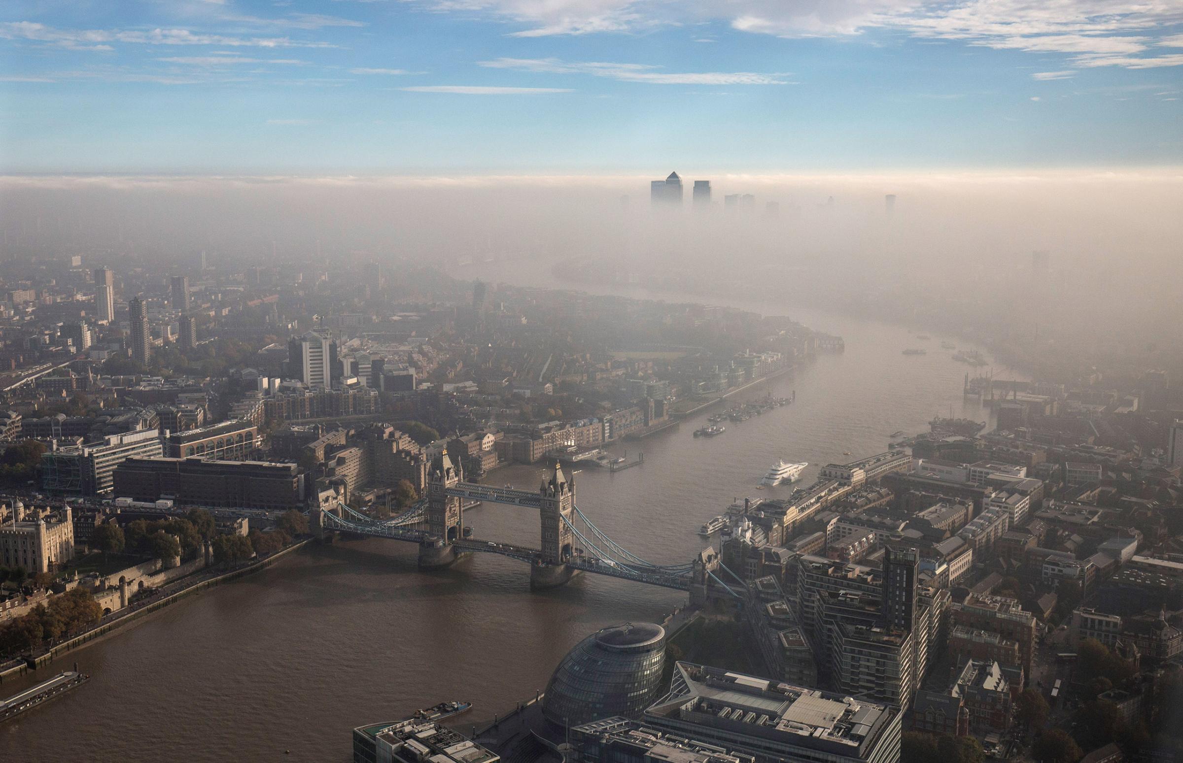A general view of Tower Bridge and the city through the fog, seen from The View From The Shard in London, on Oct. 31, 2016.