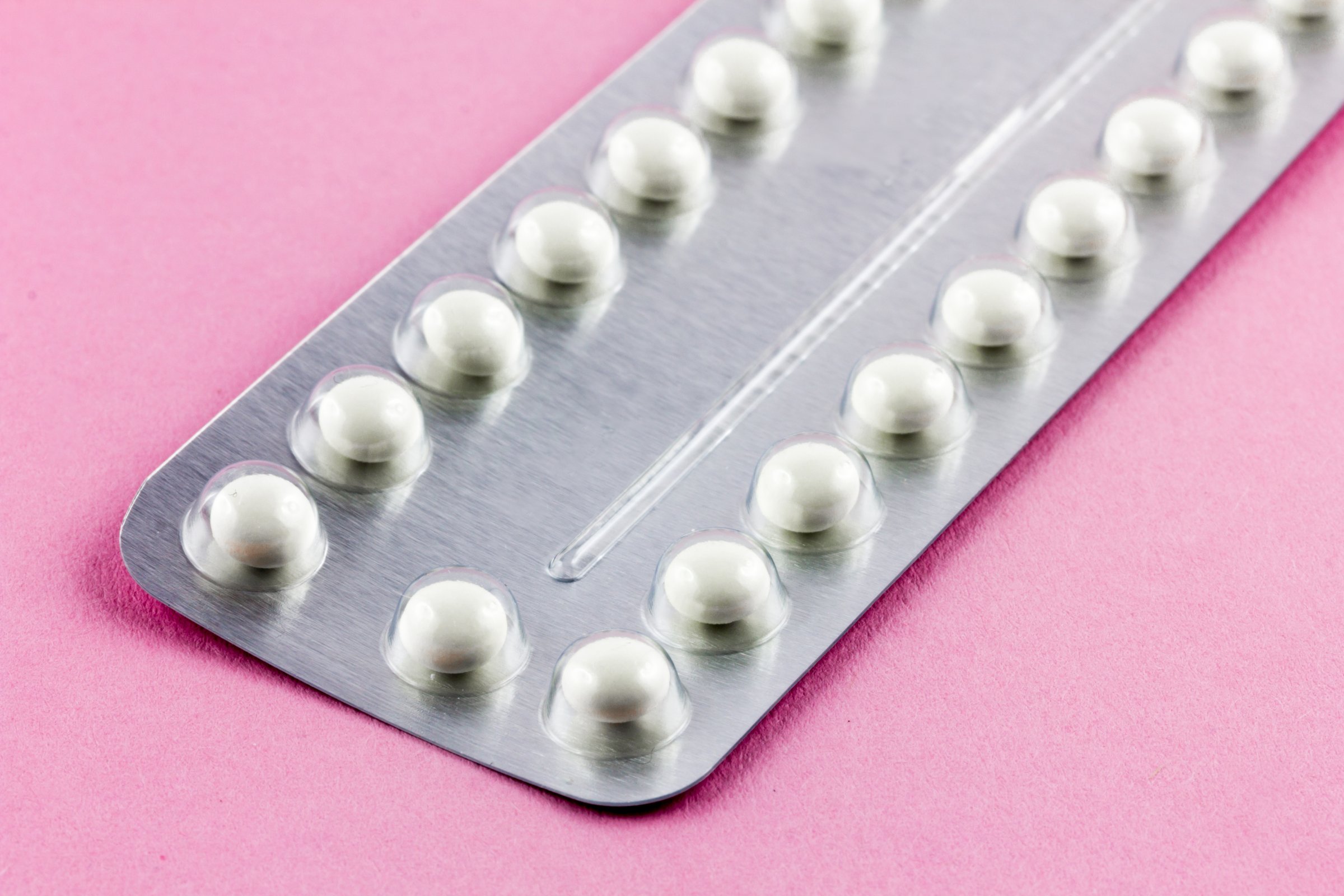 Birth control Pills on a pink background