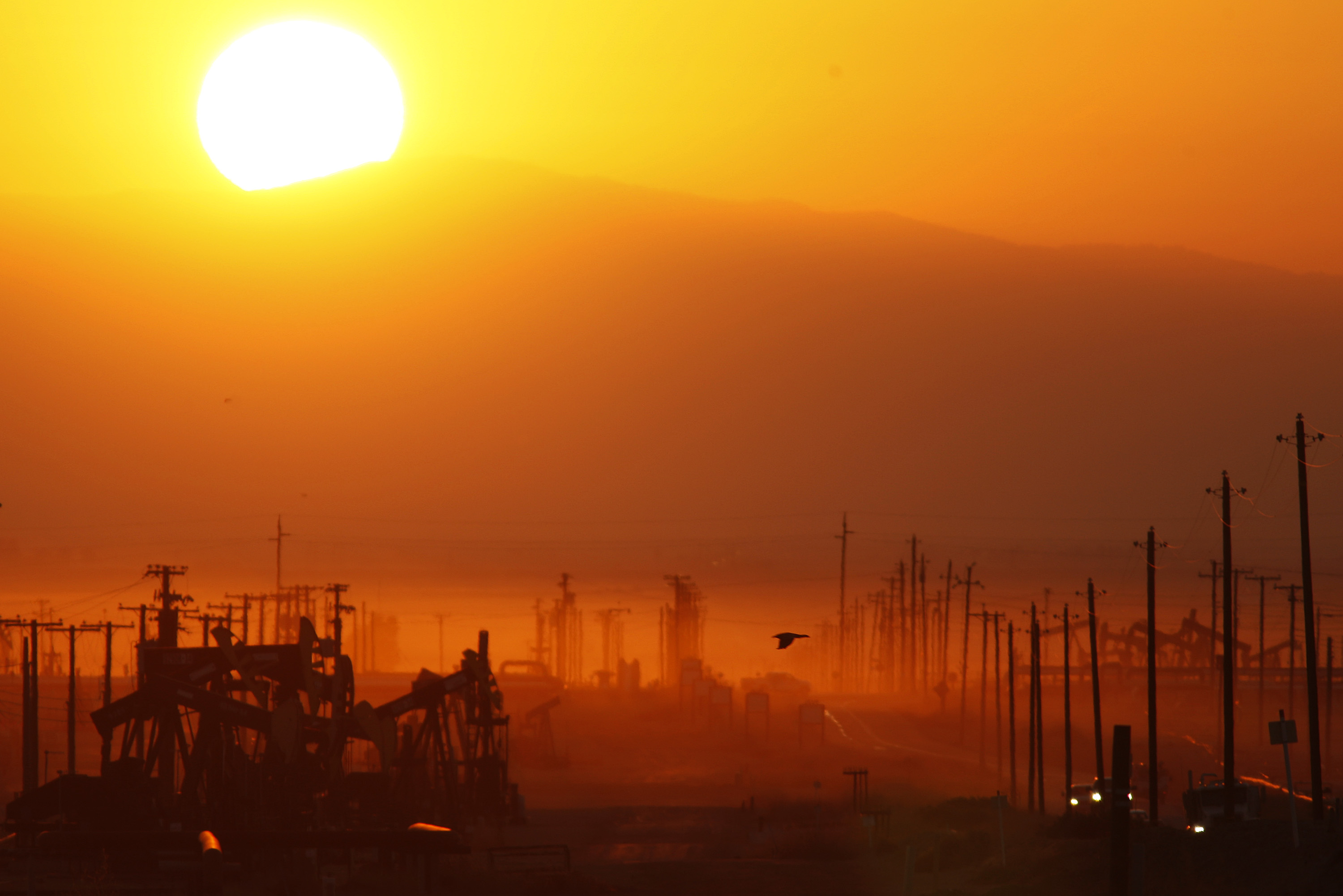 The sun rises over an oil field over the Monterey Shale formation where gas and oil extraction using hydraulic fracturing, or fracking, is on the verge of a boom on March 24, 2014 near Lost Hills, California. (David McNew—Getty Images)