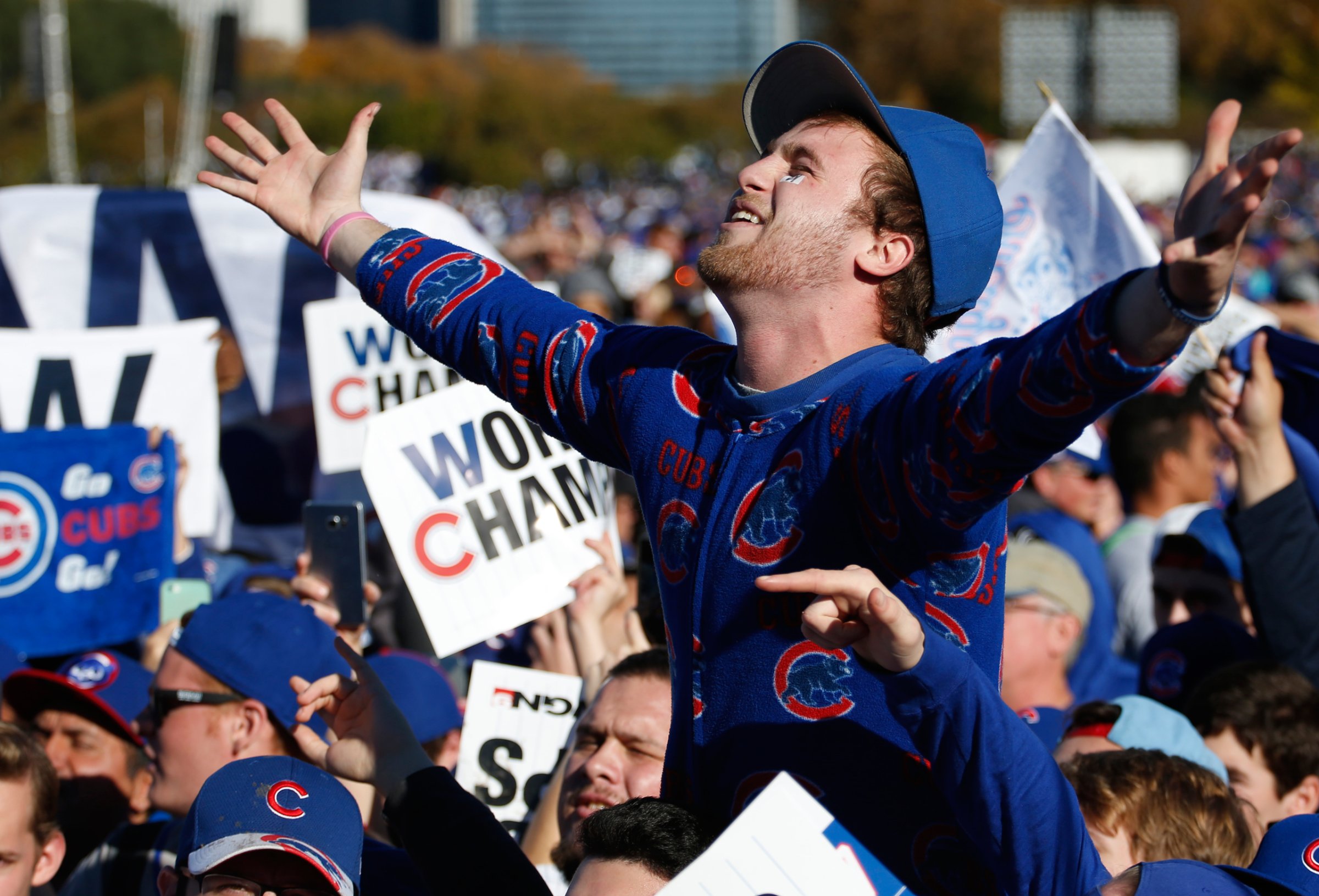 Chicago Cubs fans celebrate before a rally in Grant Park honoring the World Series baseball champions in Chicago, Friday, Nov. 4, 2016. (AP Photo/Nam Y. Huh)