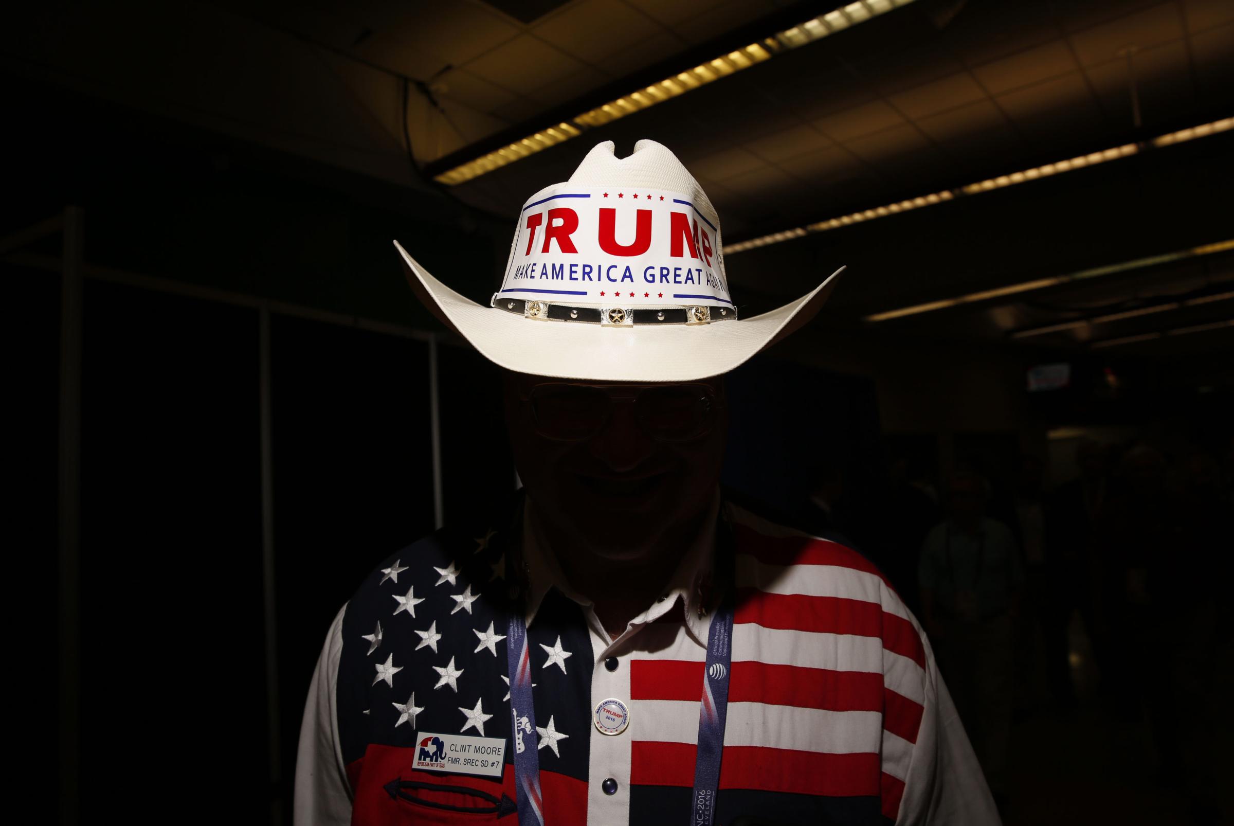 A delegate from Texas wears a cowboy hat with a campaign bumper sticker for Donald Trump during the Republican National Convention in Cleveland, Ohio, on July 20, 2016.