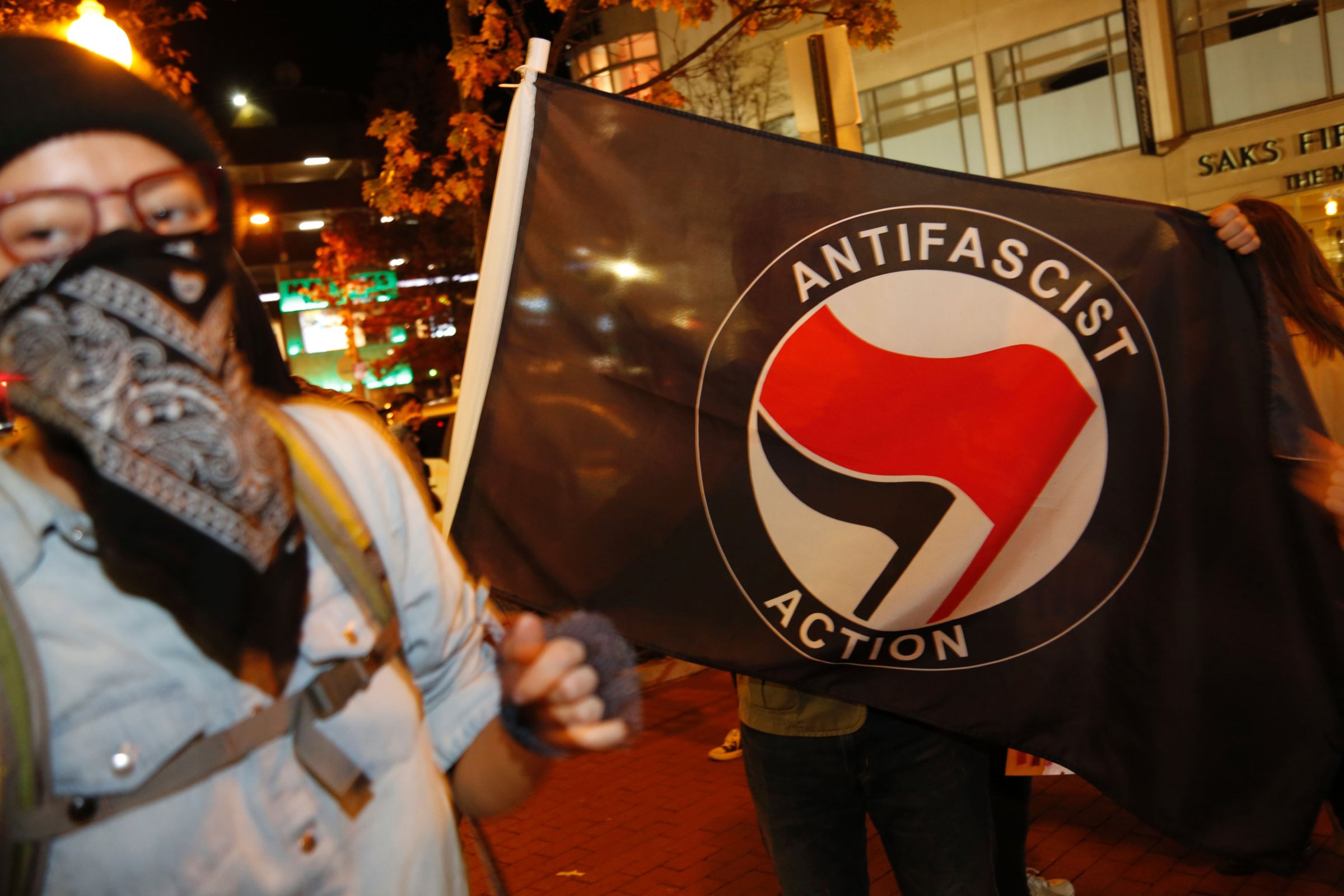 Members of DC Antifascist Coalition protest in opposition to a conference by the National Policy Institute in front of the Magliano's restaurant in Washington, DC on November 18, 2016. / AFP PHOTO / Andrew BirajANDREW BIRAJ/AFP/Getty Images