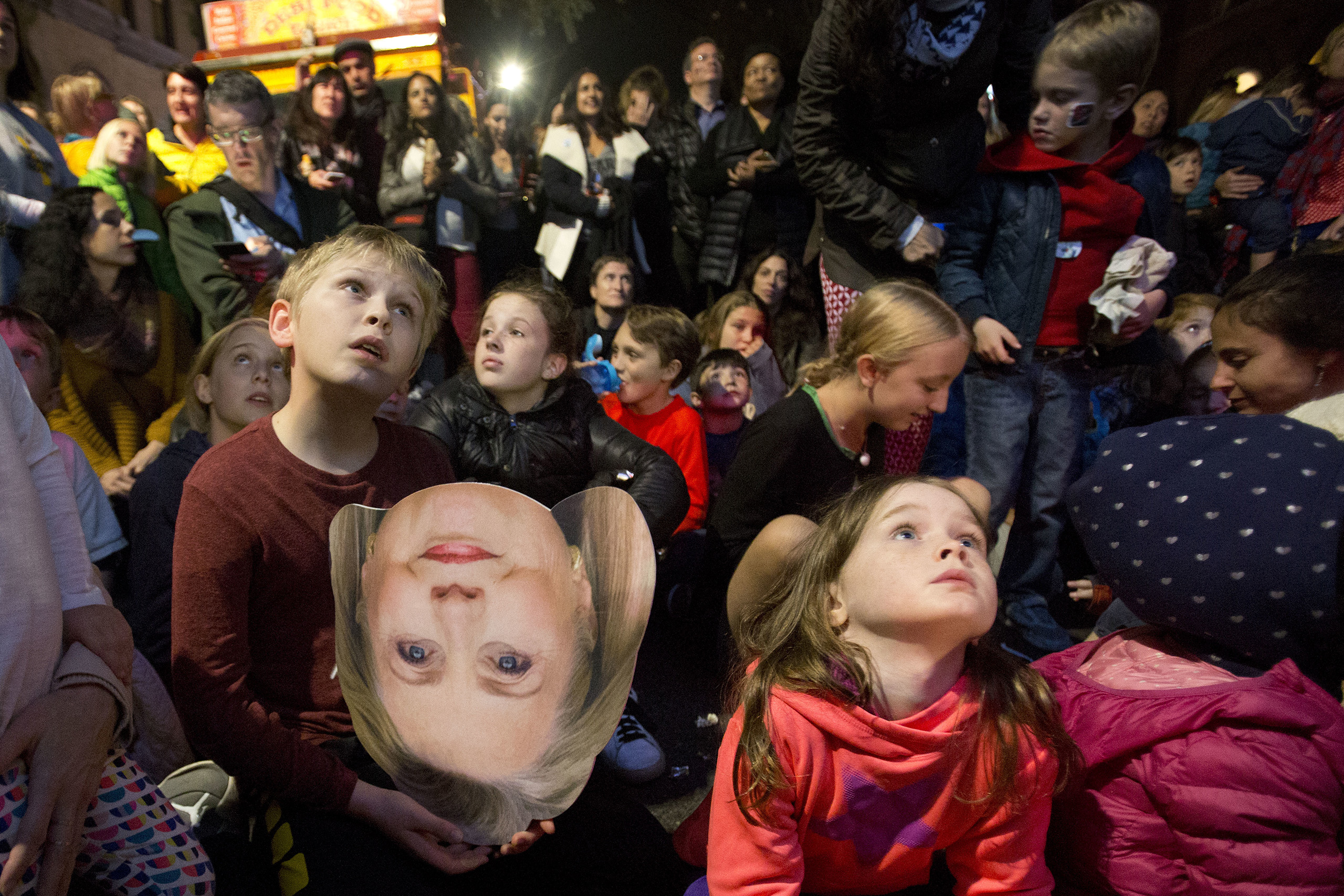 A boy holds a photo of  Hillary Clinton during an election-night block party in the Carroll Gardens neighborhood, in the in the Brooklyn borough of New York City on Nov. 8, 2016 (Mark Lennihan—AP)
