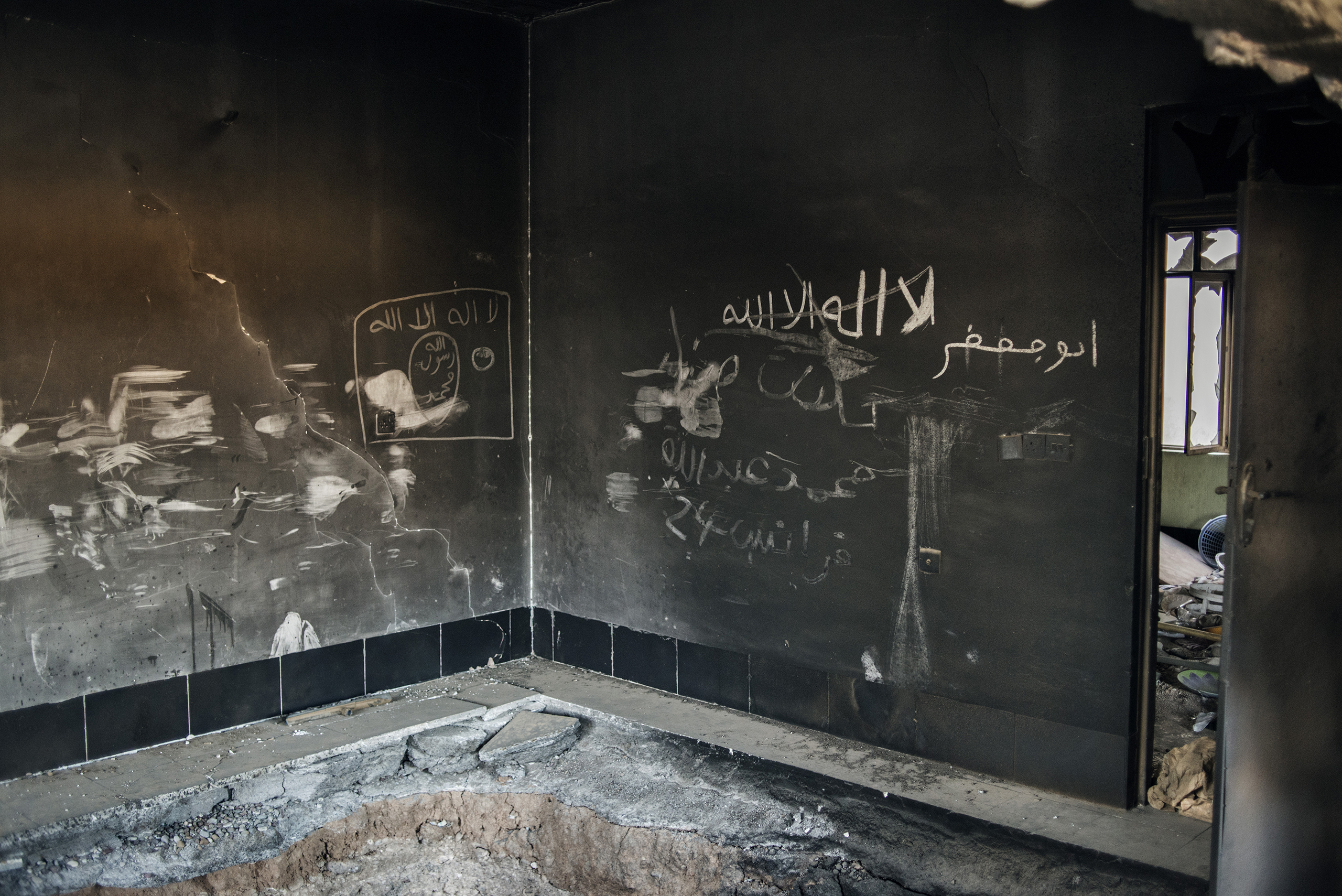 ISIS graffiti is scrawled inside a house in Bartella, a northern Iraqi town recently liberated by the Iraqi army.