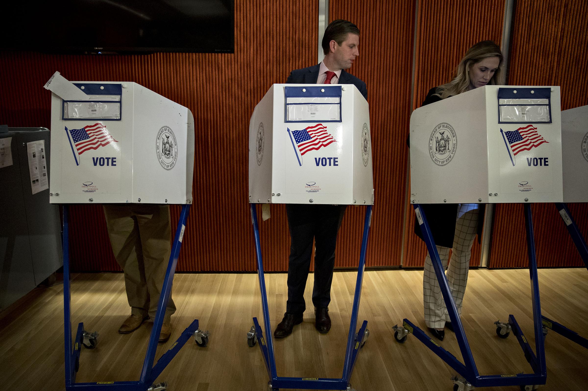 Eric Trump, son of of Republican presidential nominee Donald Trump, looks at his wife Lara's voting booth at the 53rd Street Library in New York, on Nov. 8, 2016.