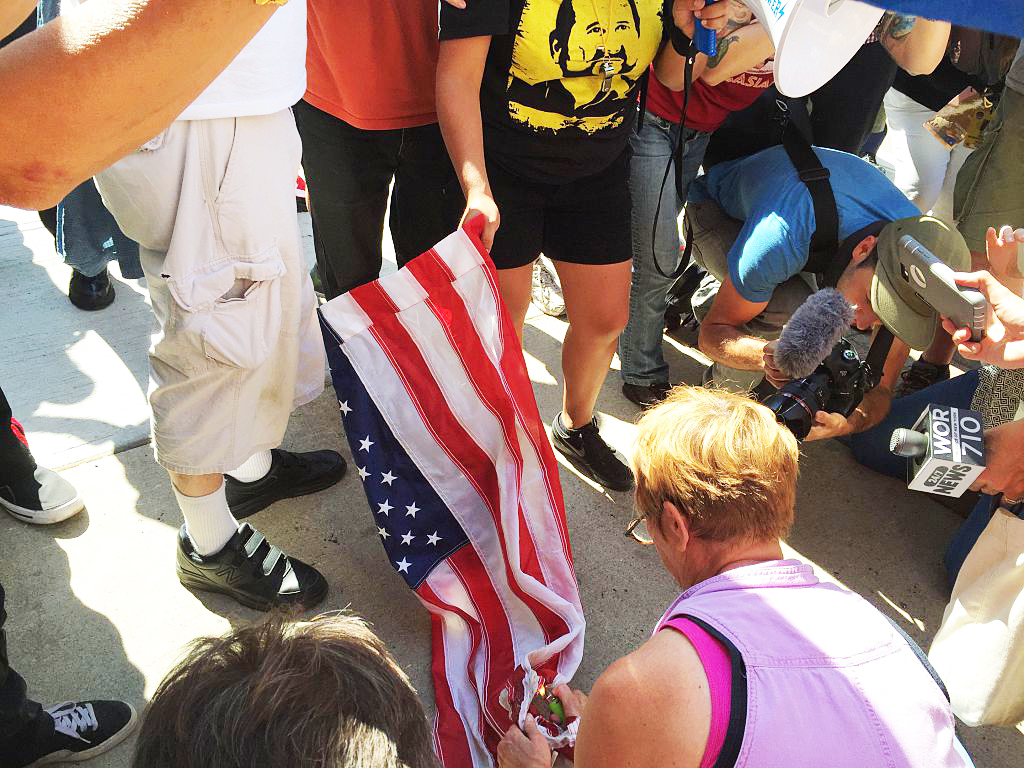 Anti-Trump protesters try to burn US flag during a rally outside the Republican National Convention in Cleveland, Ohio on July 20, 2016. (Nova Safo—AFP/Getty Images)
