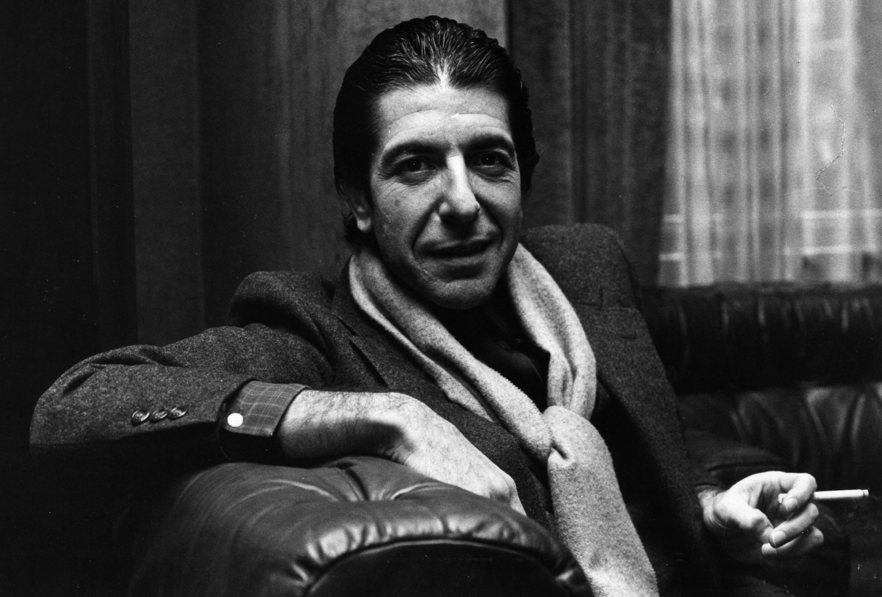 8th January 1980:  Canadian folk pop singer-songwriter Leonard Cohen shares a joke and smokes a cigarette. (Evening Standard—Getty Images)