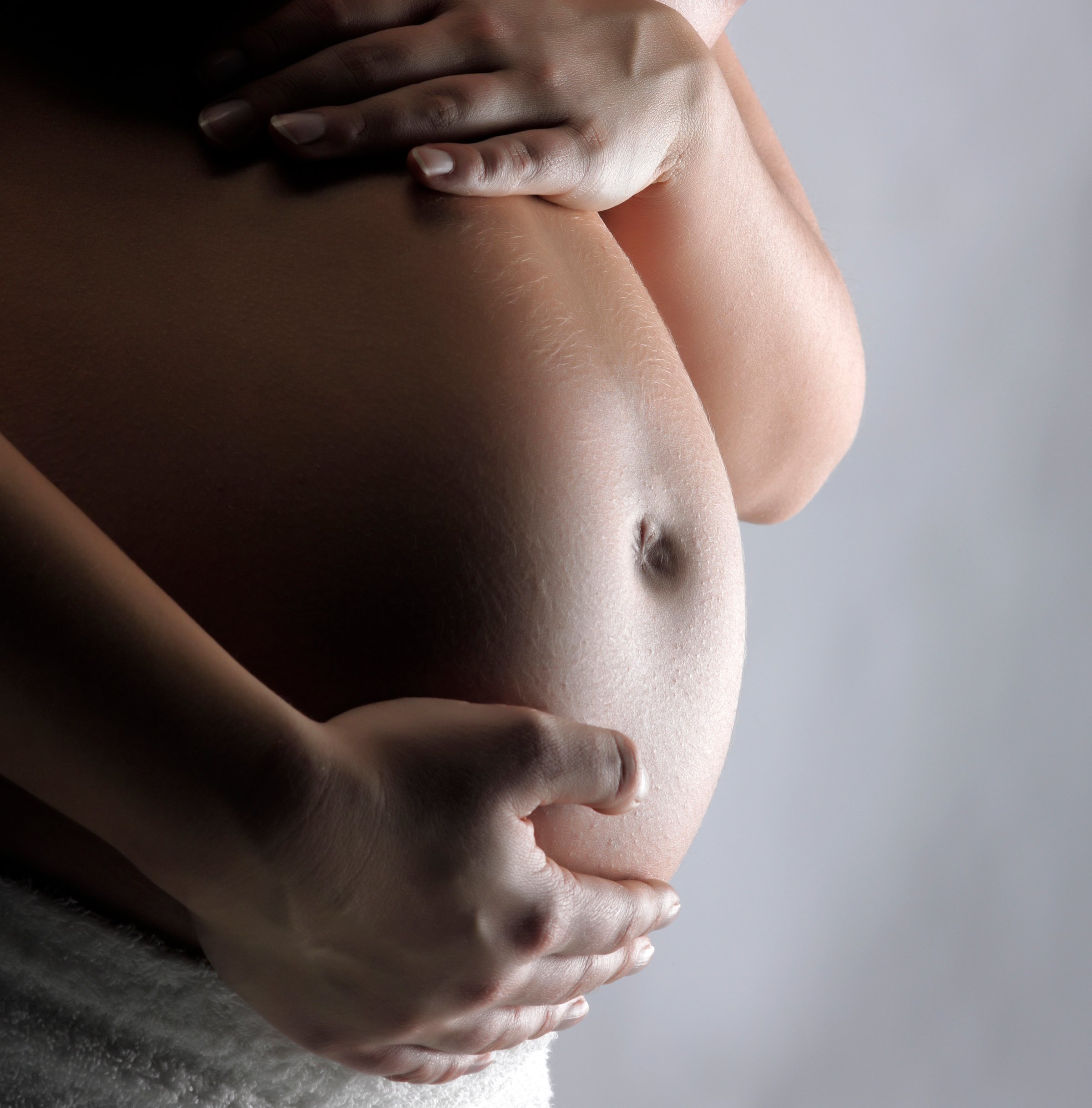 Pregnant woman supporting tummy