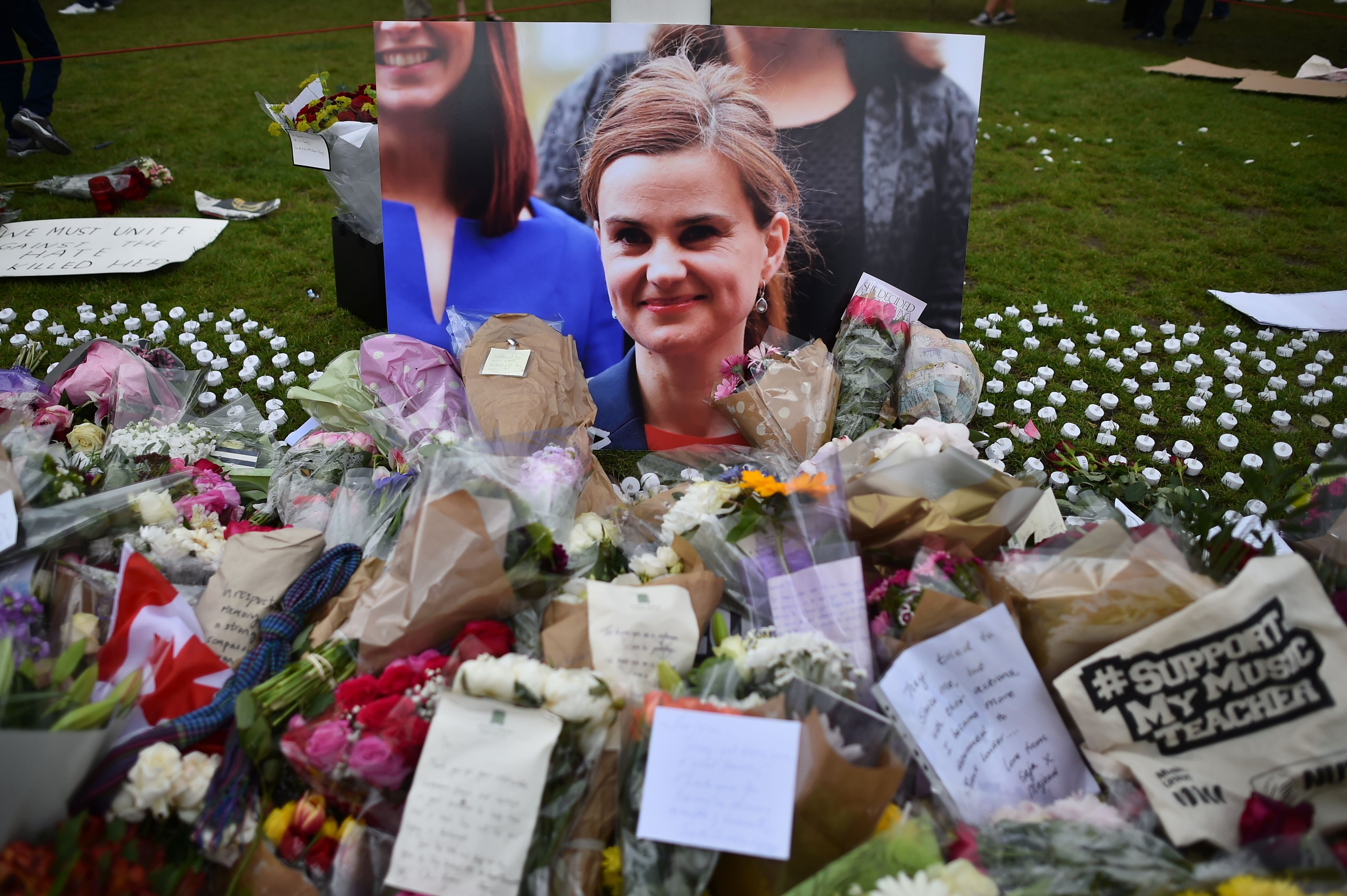 Flowers and tributes are piled in remebrance against a photograph of slain Labour MP Jo Cox in Parliament Square central London on June 18, 2016.  Thomas Mair has been found guilty of Cox's murder. (BEN STANSALL—AFP/Getty Images)