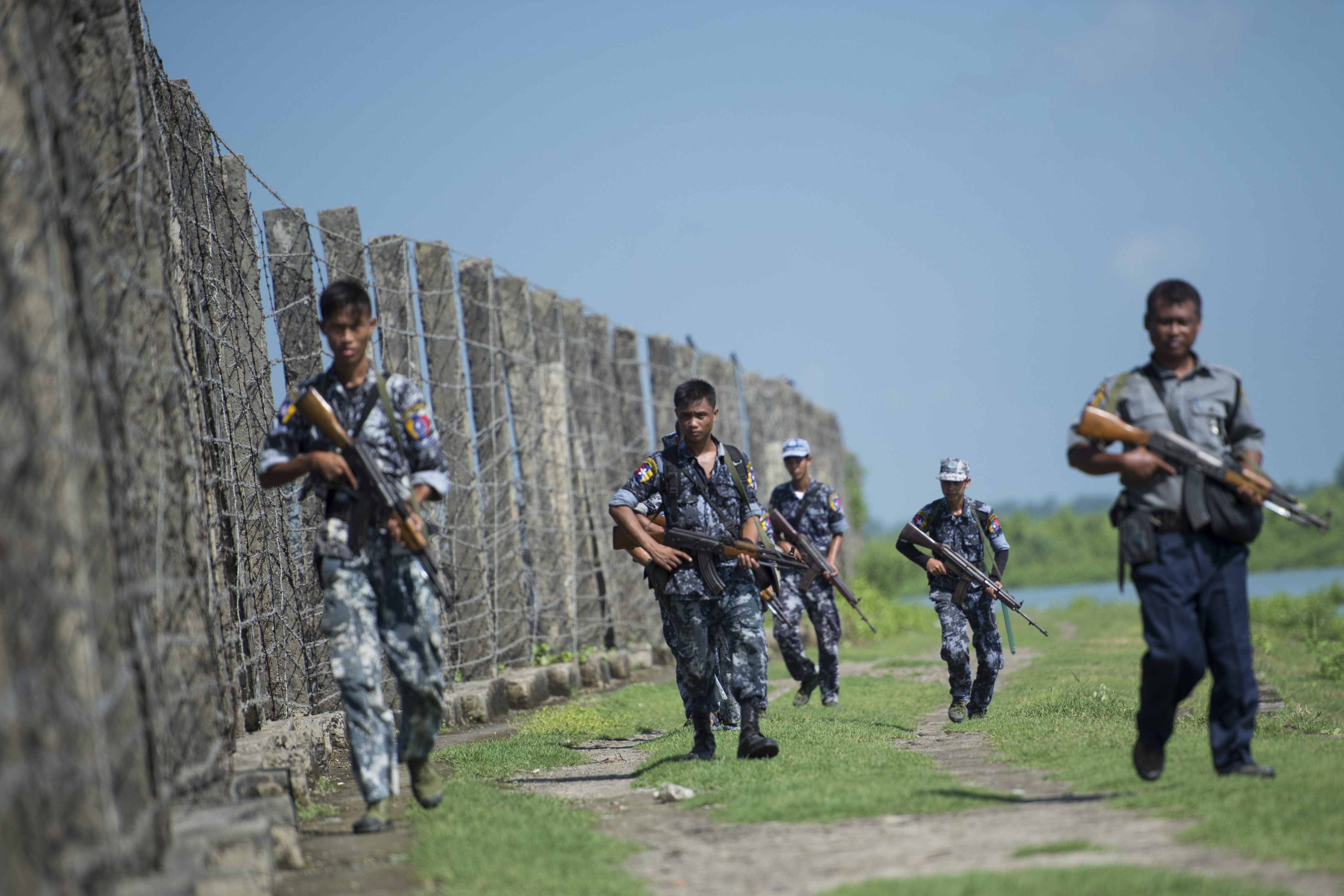 Armed Burma border police scan the area near the Bangladesh border  in Maungdaw, Arakan State on October 15, 2016 (Ye Aung Thu—AFP / Getty Images)