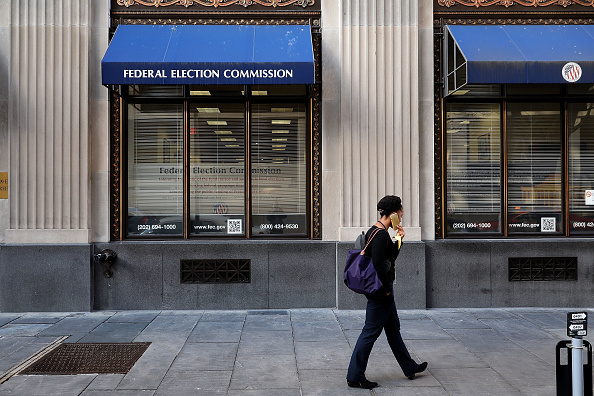 A pedestrian walks past the Federal Election Commission's headquarters October 24, 2016 in Washington, DC.