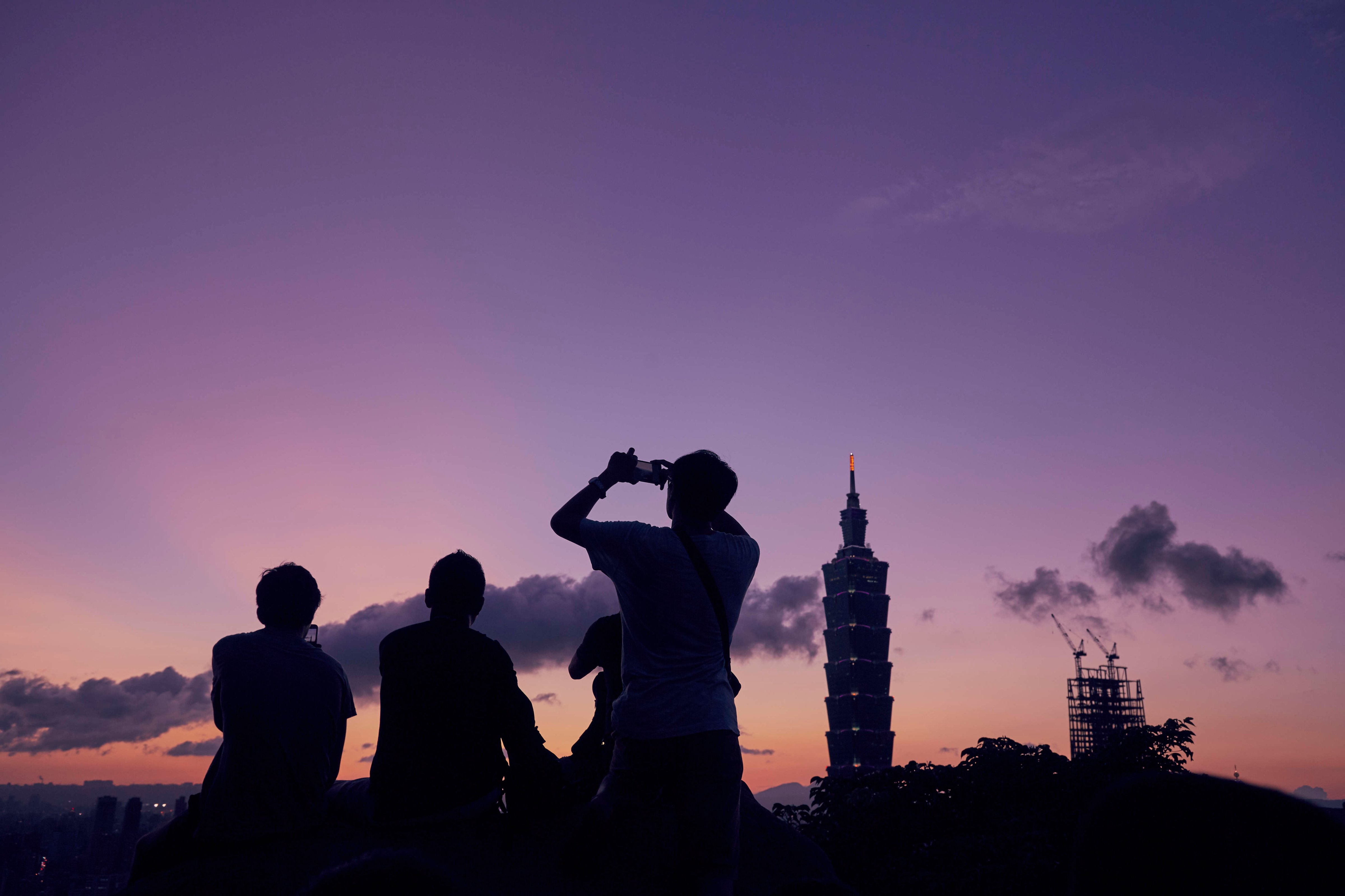 People gather the watch the sunset over Taipei. The Elephant Mountain hiking trail attracts photographers and tourists whenever there's a chance of a nice sunset (Craig Ferguson—LightRocket/Getty Images)
