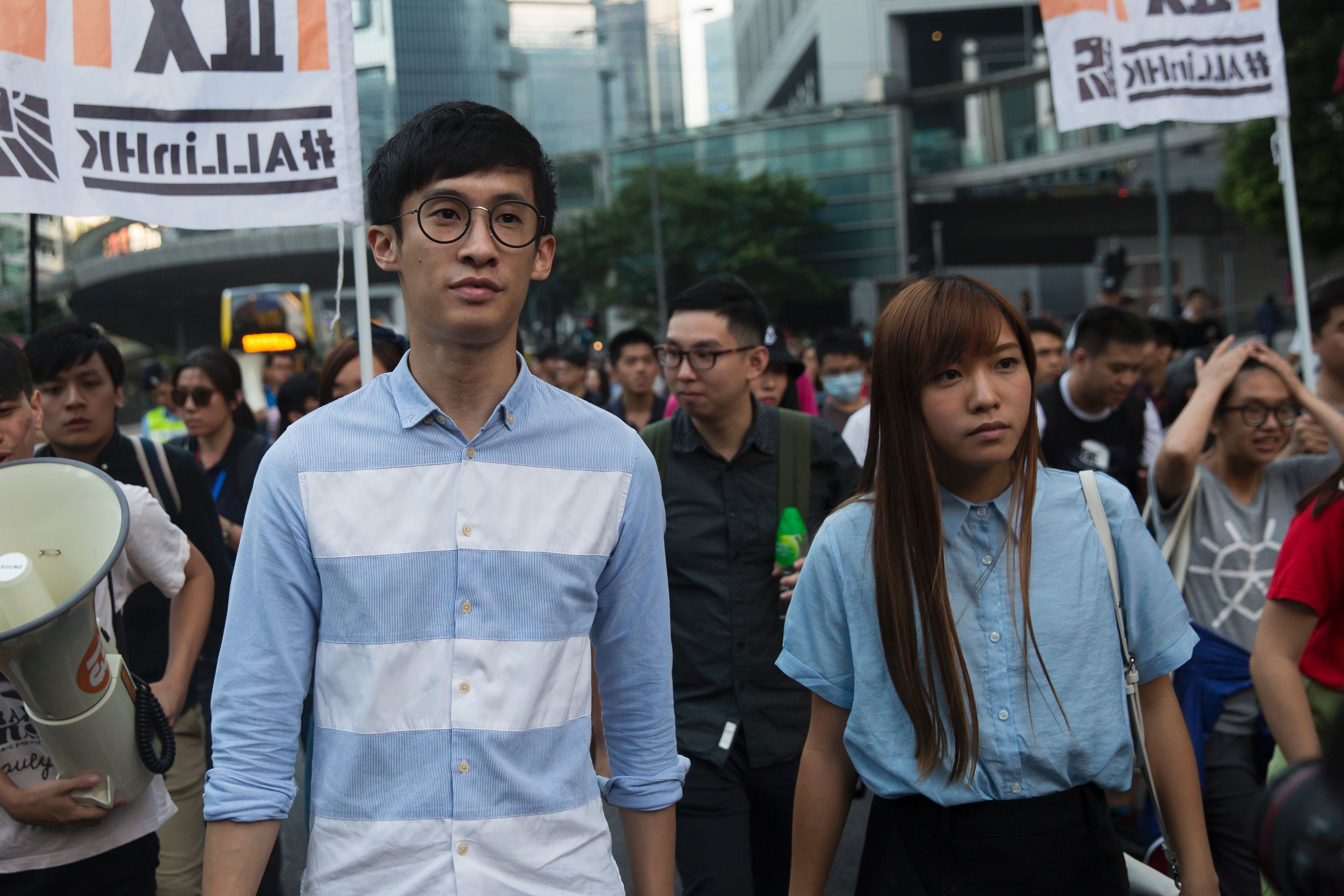 Sixtus "Baggio" Leung, left, and Yau Wai-ching, both elected lawmakers of Youngspiration party, march during a protest in Hong Kong on Nov. 6, 2016 (Isaac Lawrence—AFP/Getty Images)