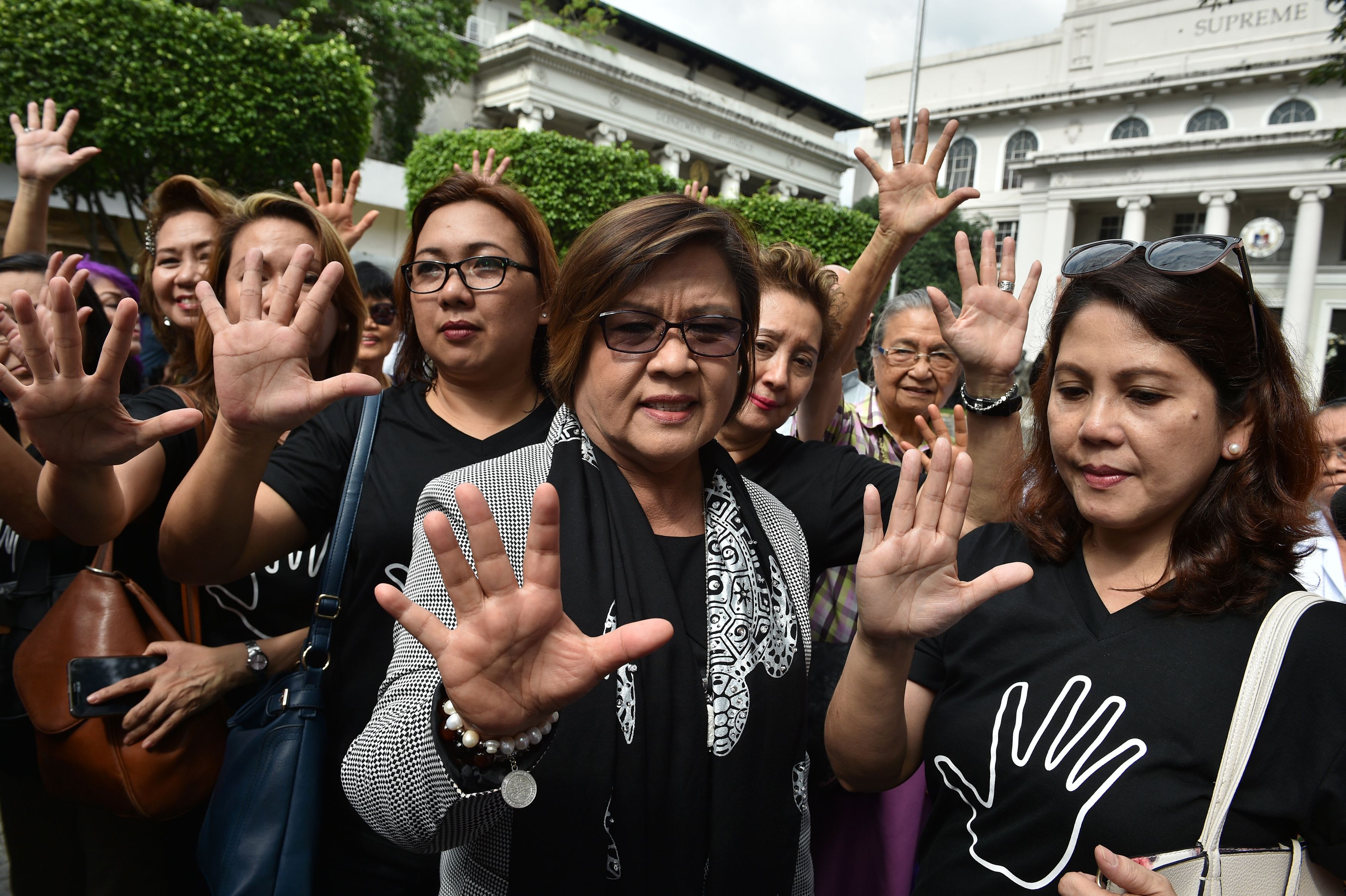 Senator Leila de Lima, center, gestures with supporters after filing her petition for habeas data against Philippine President Rodrigo Duterte at the Supreme Court in Manila on Nov. 7, 2016. De Lima, former Justice Secretary who is a leading critic of Duterte's war on drugs, launched a Senate probe into the surge of killings since Duterte took office on June 30, which led to her being ousted on Sept. 19 by pro-Duterte Senators as head of the Senate justice committee. (Ted Aljibe—AFP/Getty Images)