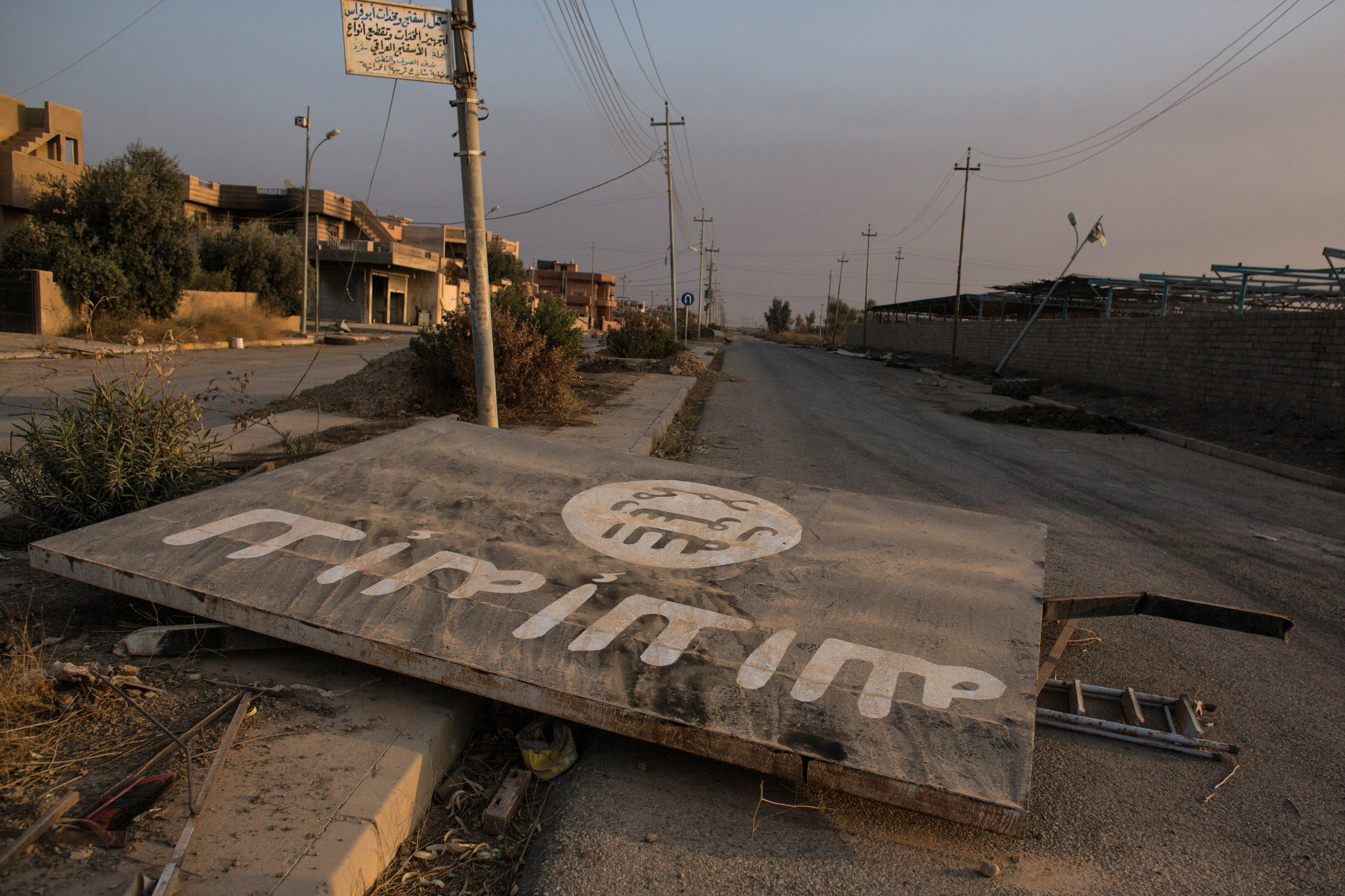 An ISIL billboard is seen destroyed in the middle of the road Qaraqosh, Iraq on Nov. 8, 2016 (Chris McGrath—Getty Images)