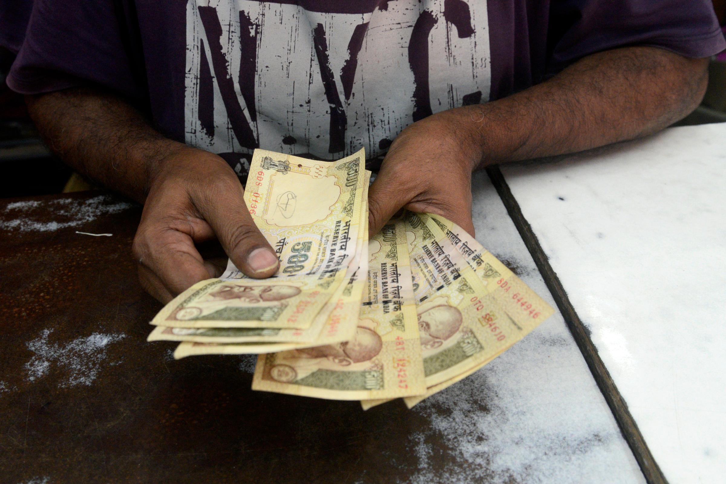 A shop owner counts Rs.500 banknote as he have to exchange