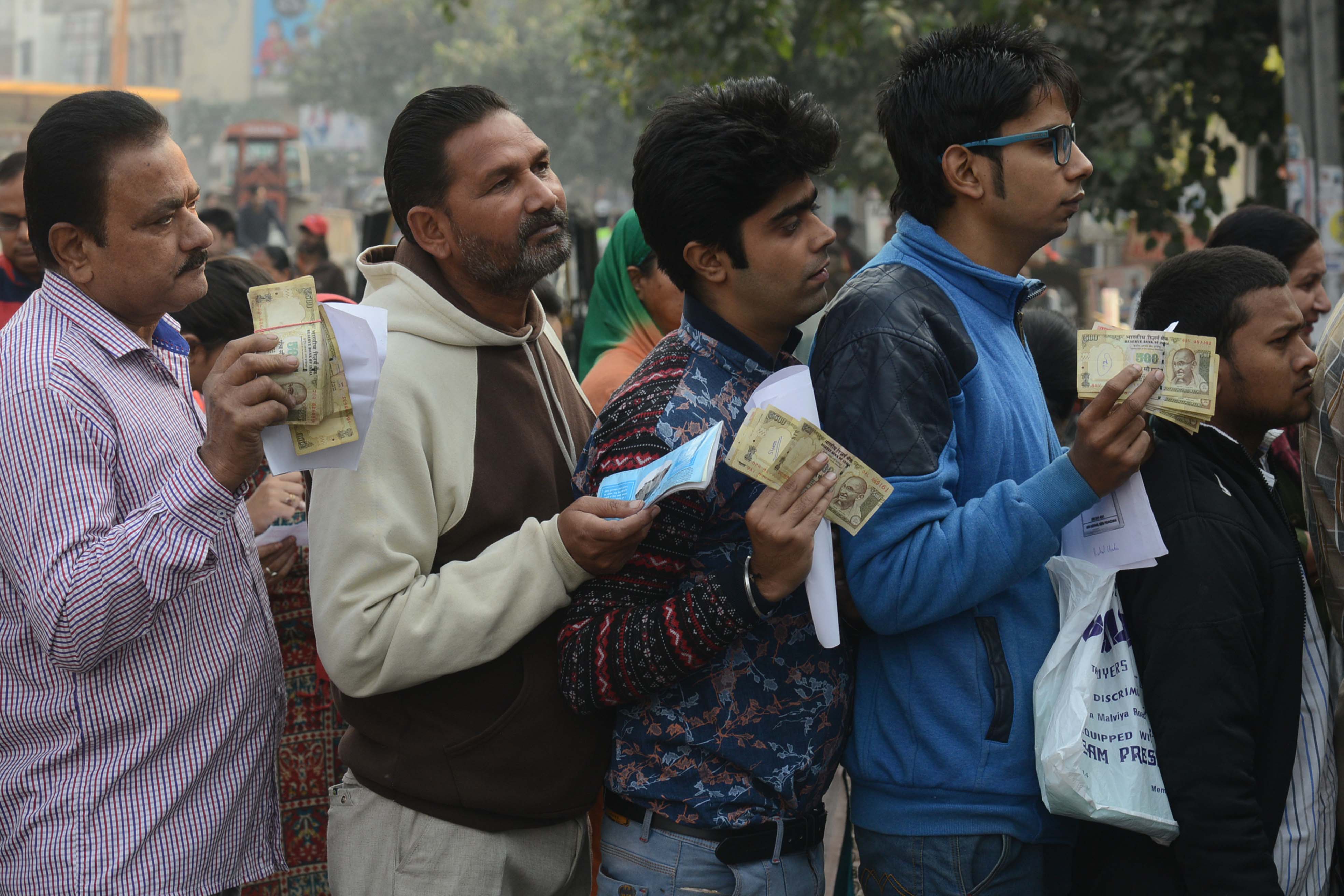 Indian people queue outside a bank as they wait to deposit and exchange 500 and 1000 rupee notes in Amritsar on November 13, 2016. (NARINDER NANU—AFP/Getty Images)