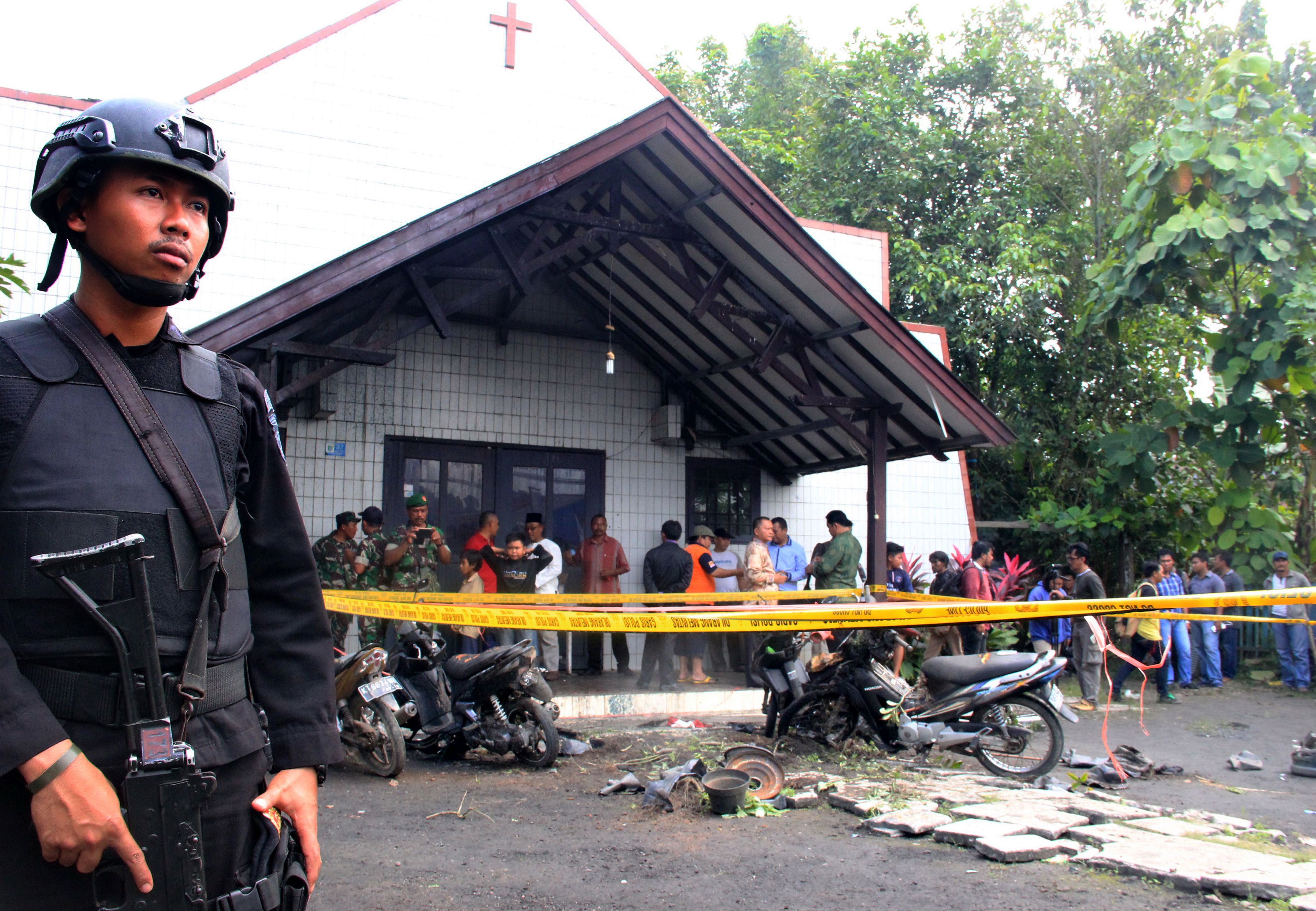 An Indonesian policeman stands guard outside the Oikume Church  in Samarinda, Indonesia's East Kalimantan province, on Nov. 13, 2016, after a man allegedly threw a Molotov cocktail toward it, killing a child and wounding three others (AFP/Getty Images)