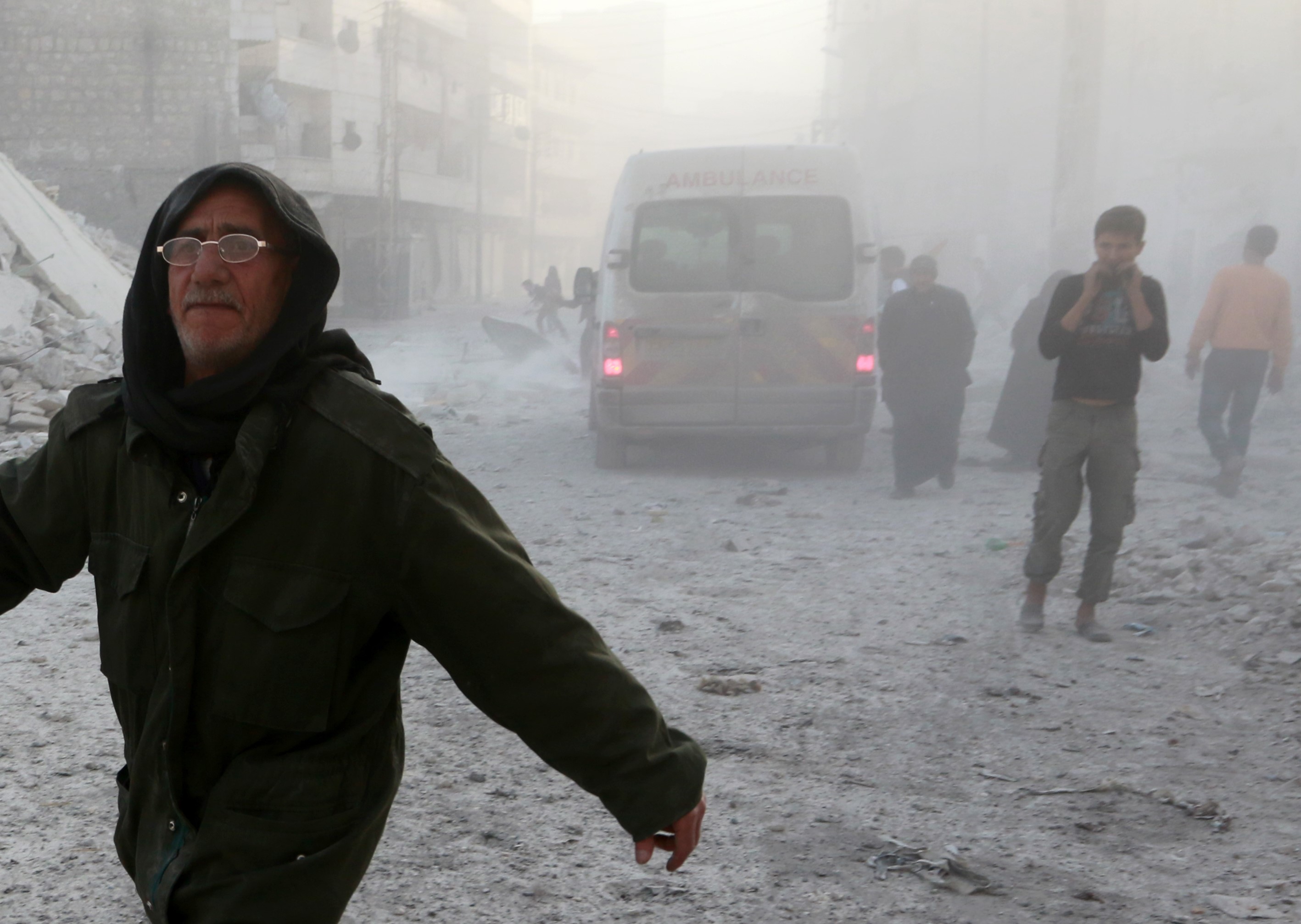 People run away after the war crafts belonging to the Syrian and Russian forces carried out airstrikes on residential areas at the opposition controlled Salihin neighborhood of Aleppo, Syria on Nov. 15, 2016. (Jawad al Rifai—Anadolu Agency/Getty Images)