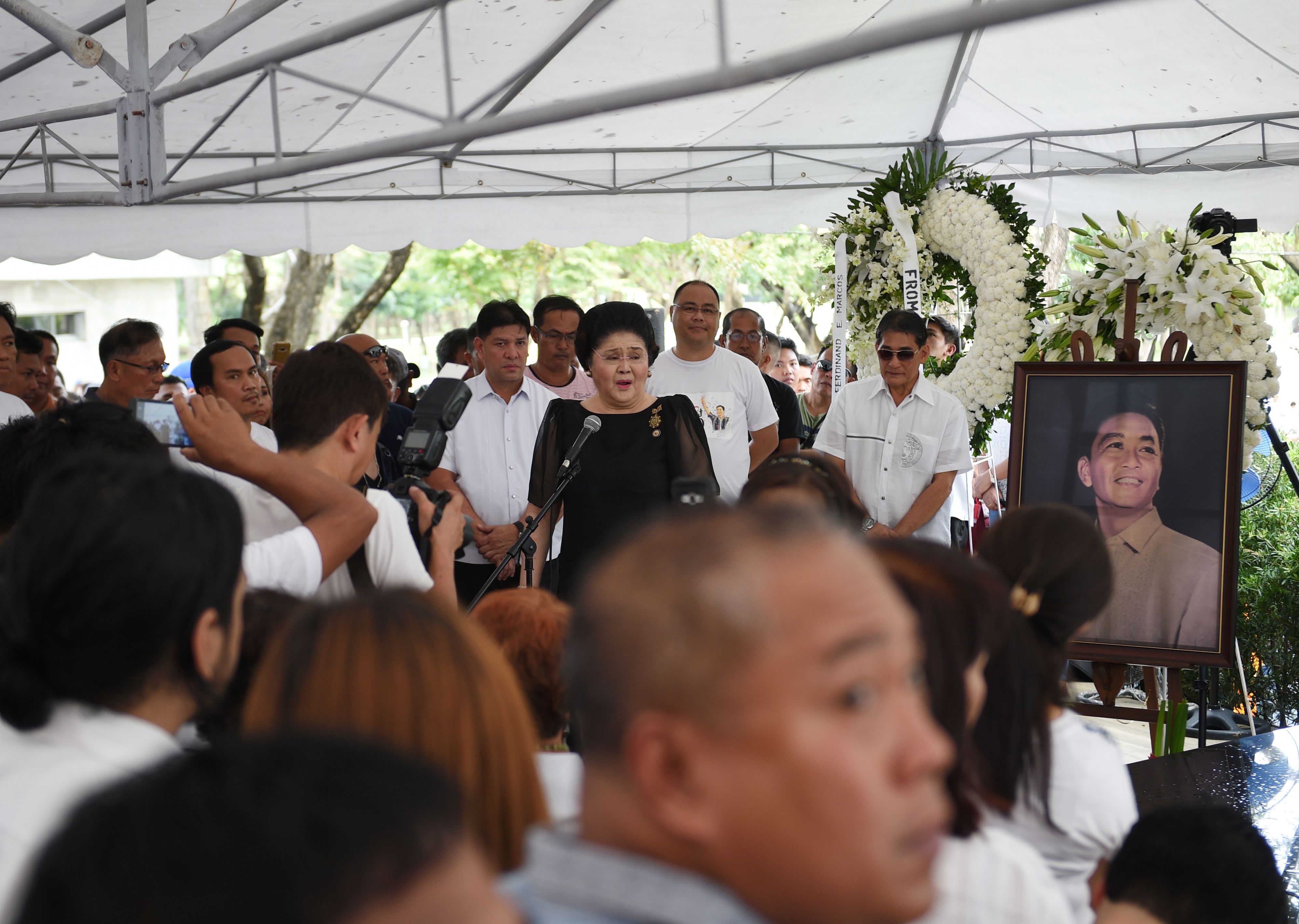Philippines' former First Lady Imelda Marcos, center, speaks to supporters at the graveyard of the late dictator Ferdinand Marcos at the Heroes' Cemetery in Manila on Nov. 19, 2016, a day after the late dictator was buried. (Ted Aljibe—AFP/Getty Images)