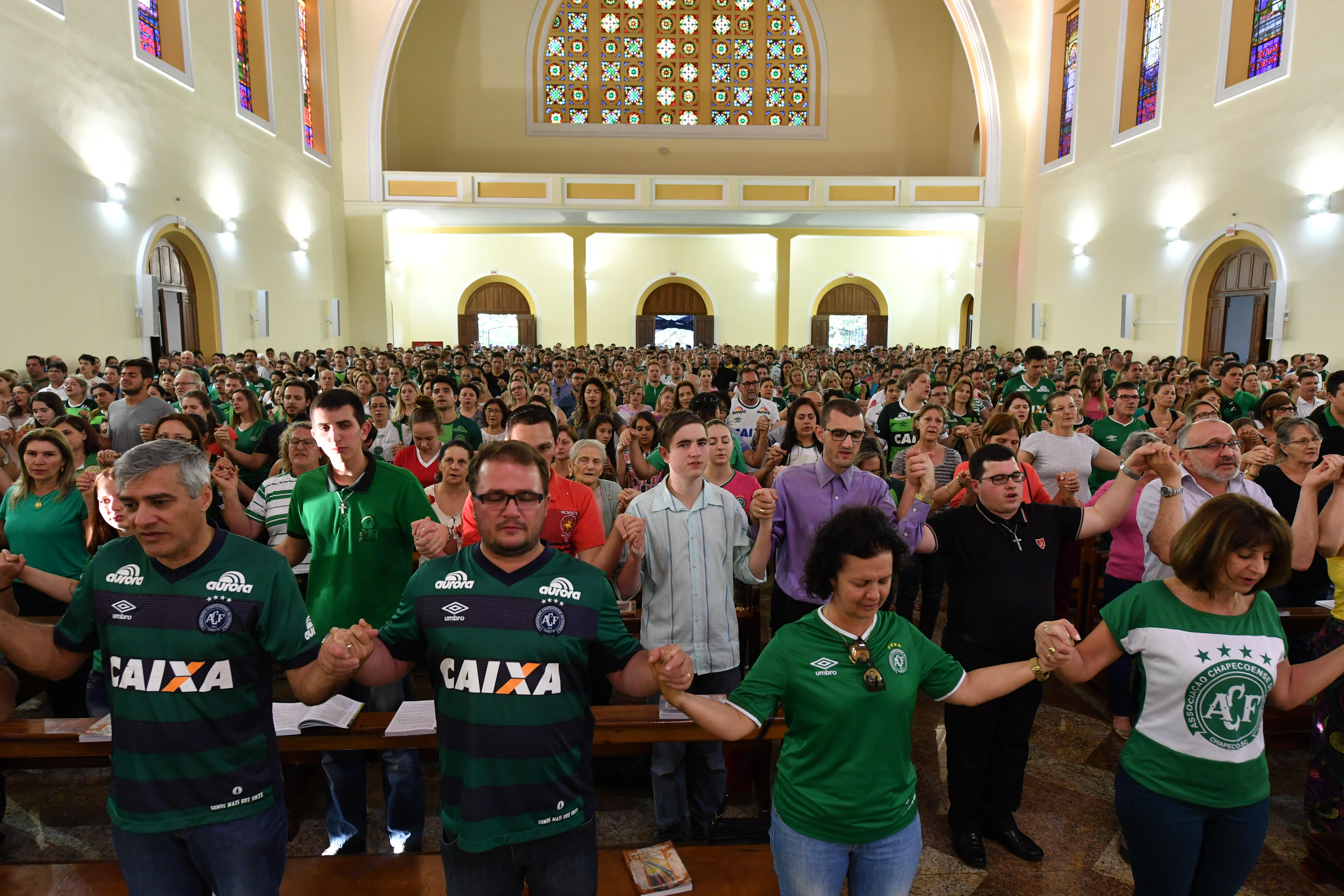 People attend a mass in memoriam of the players of Brazilian team Chapecoense Real killed in a plane crash in the Colombian mountains, in Chapeco, in the southern Brazilian state of Santa Catarina, on November 29, 2016. (NELSON ALMEIDA—AFP/Getty Images)