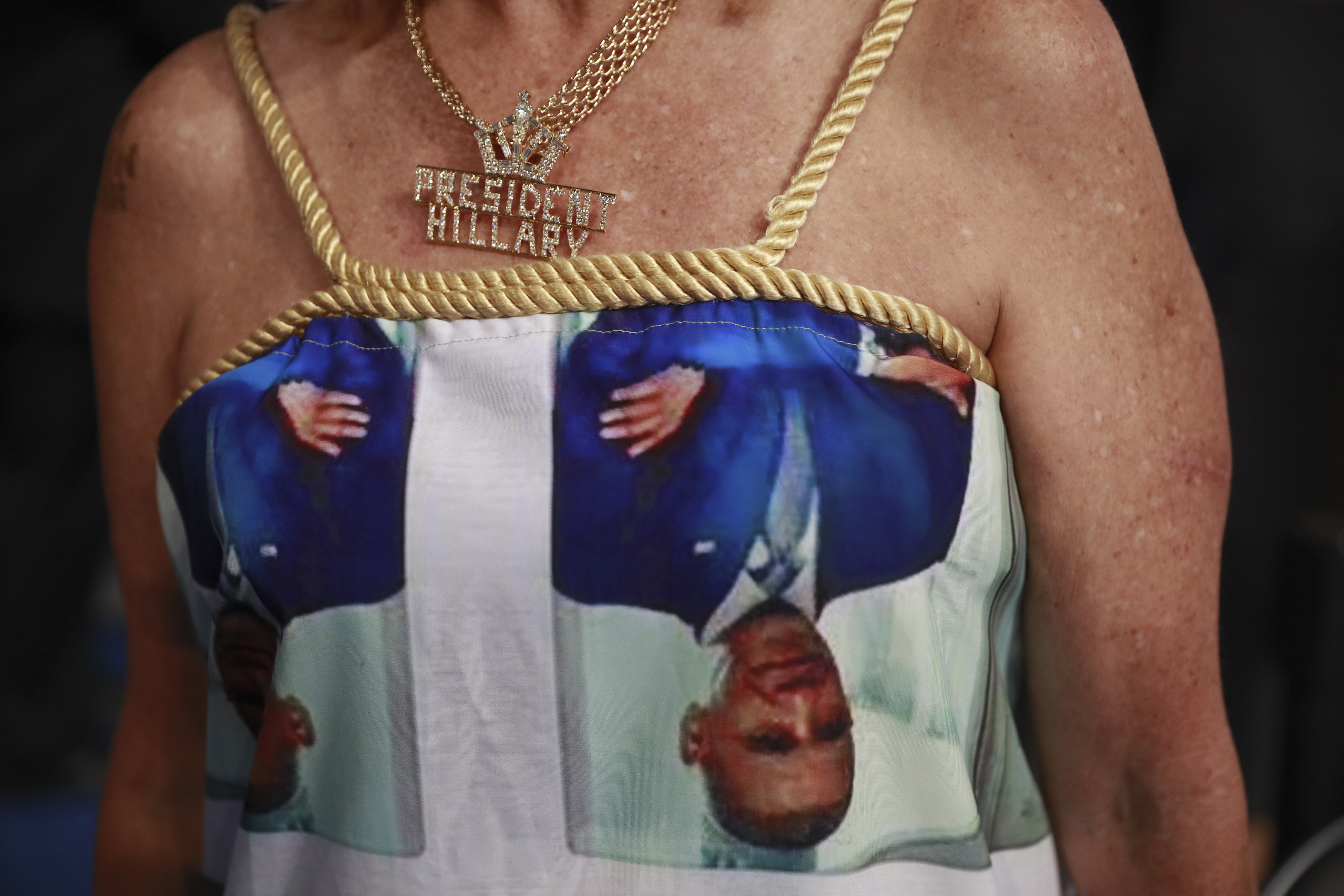 A delegate wears a dress covered in photos of President Barack Obama and first lady Michelle Obama at the Wells Fargo Center on the third day of the Democratic National Convention in Philadelphia, on July 27, 2016.