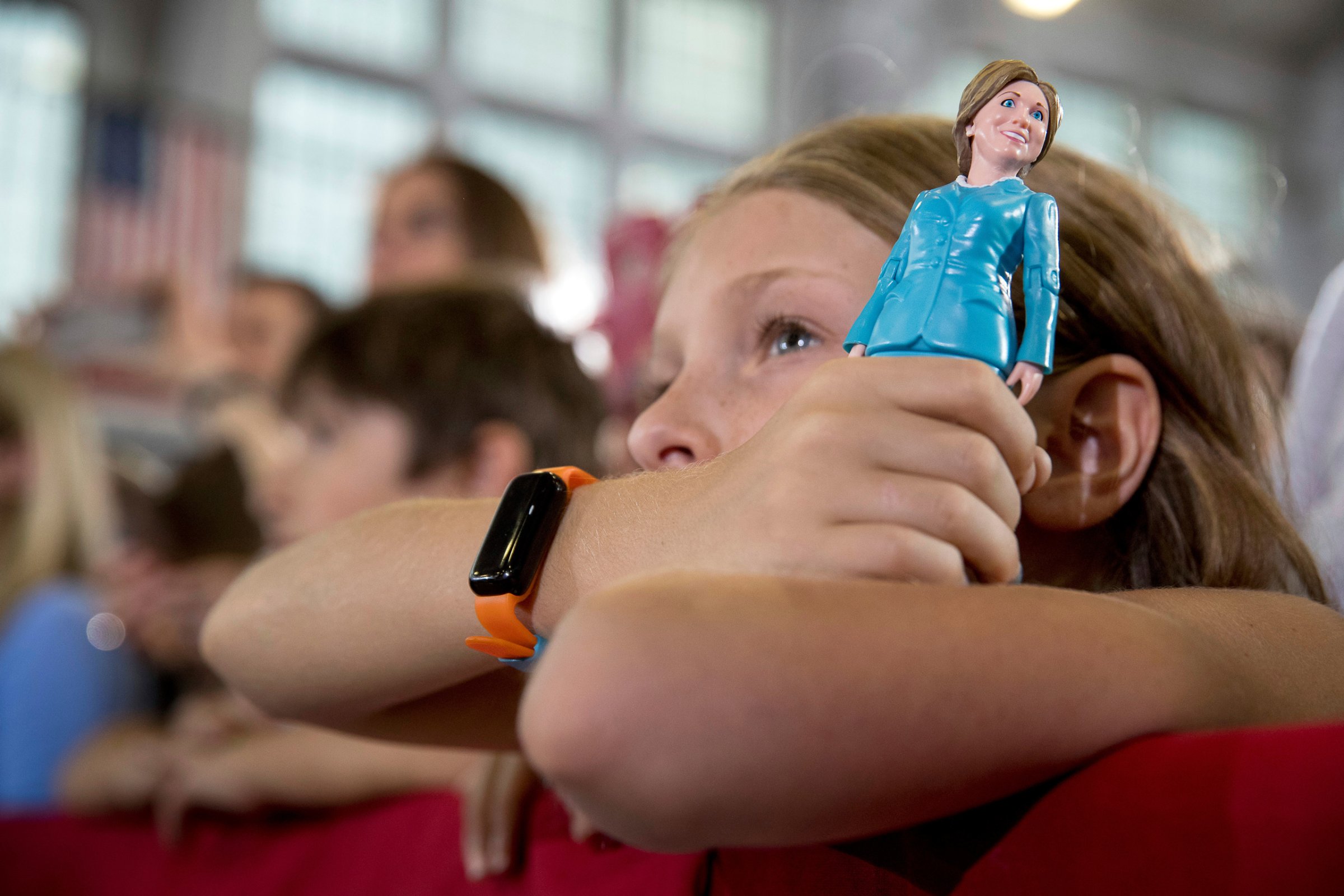A girl in the audience holds a figurine of Democratic presidential candidate Hillary Clinton as Clinton speaks at a rally at Goodyear Hall and Theater in Akron, Ohio, Monday, Oct. 3, 2016. (AP Photo/Andrew Harnik)