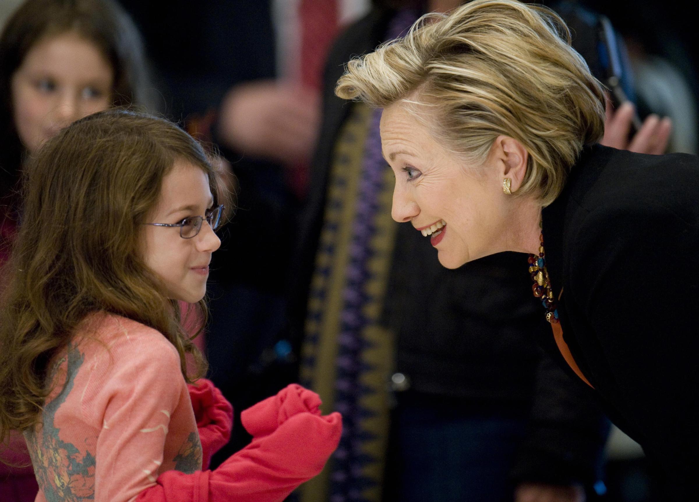Hillary Clinton talks to a little girl at her polling station before voting in the 2008 Presidential Election in Chappaqua, New York, on Nov. 4, 2008.