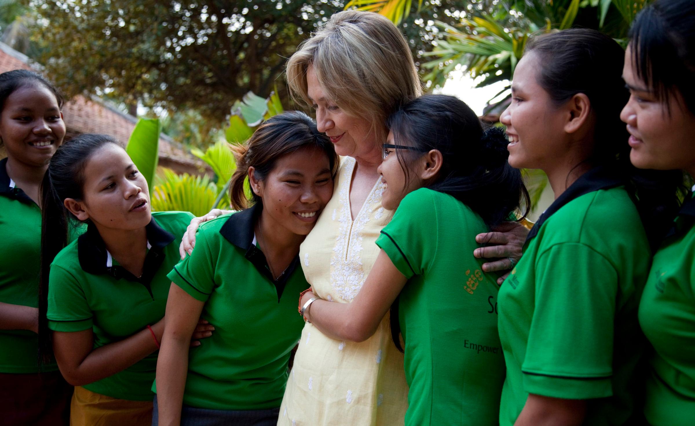 Girls hug US Secretary of State Hillary