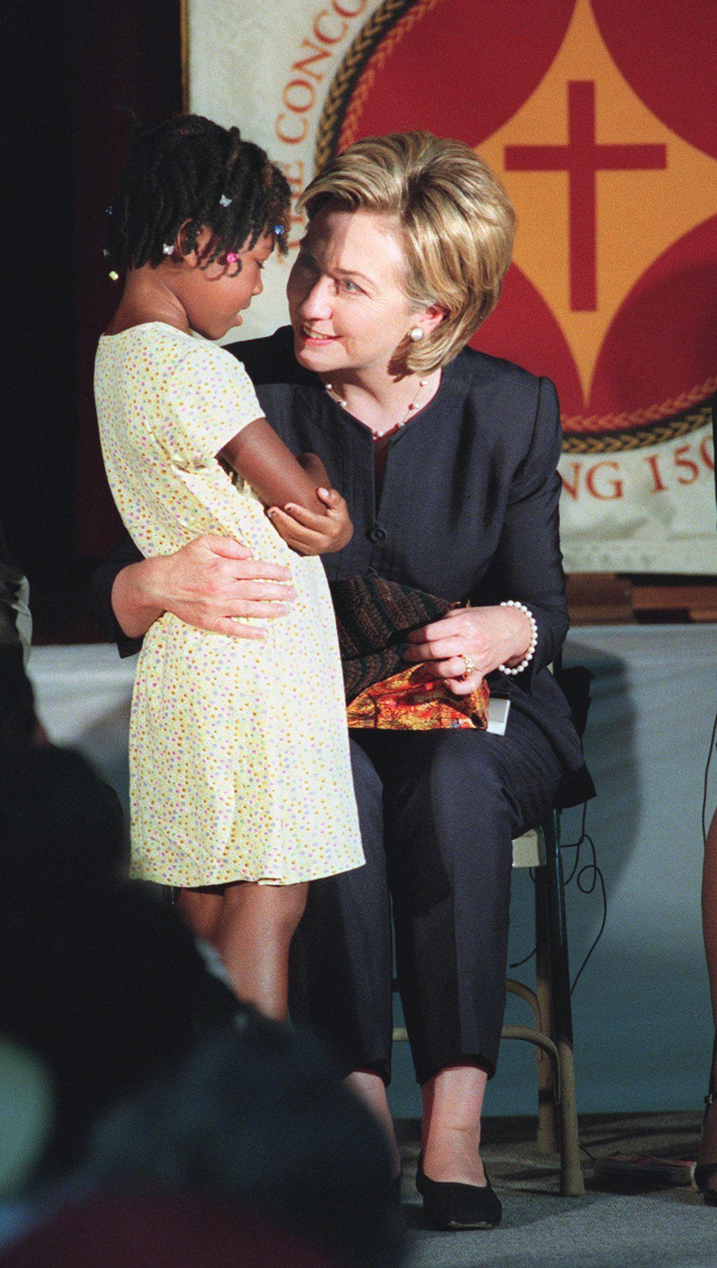US First Lady Hillary Clinton (R) accepts a gift f