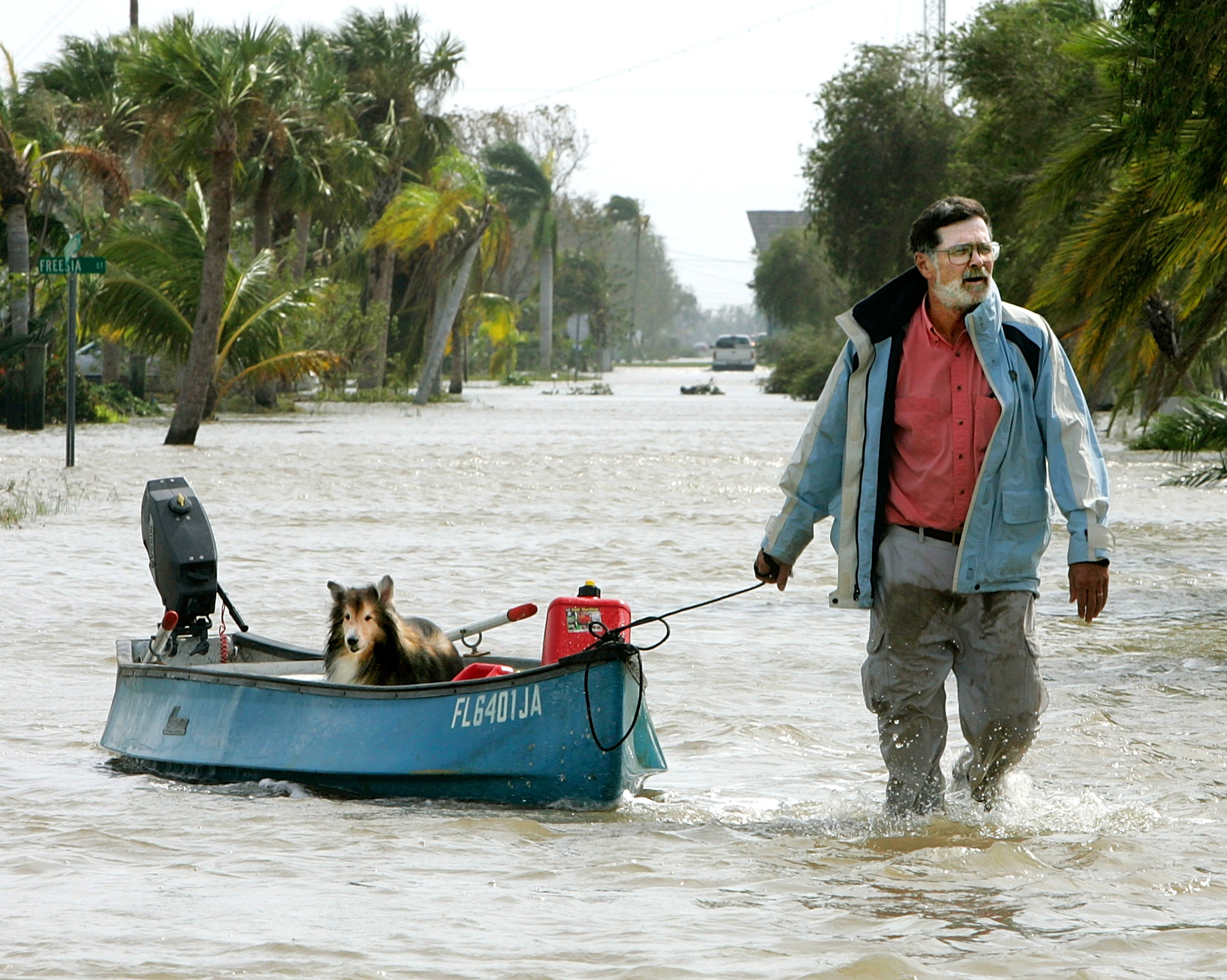 Steve Burke pulls his dog, Toby, down a flooded street in a canoe after Hurricane Wilma arrived this morning Oct. 24, 2005 in Everglades City, Florida. (Carlo Allegri—Getty Images)