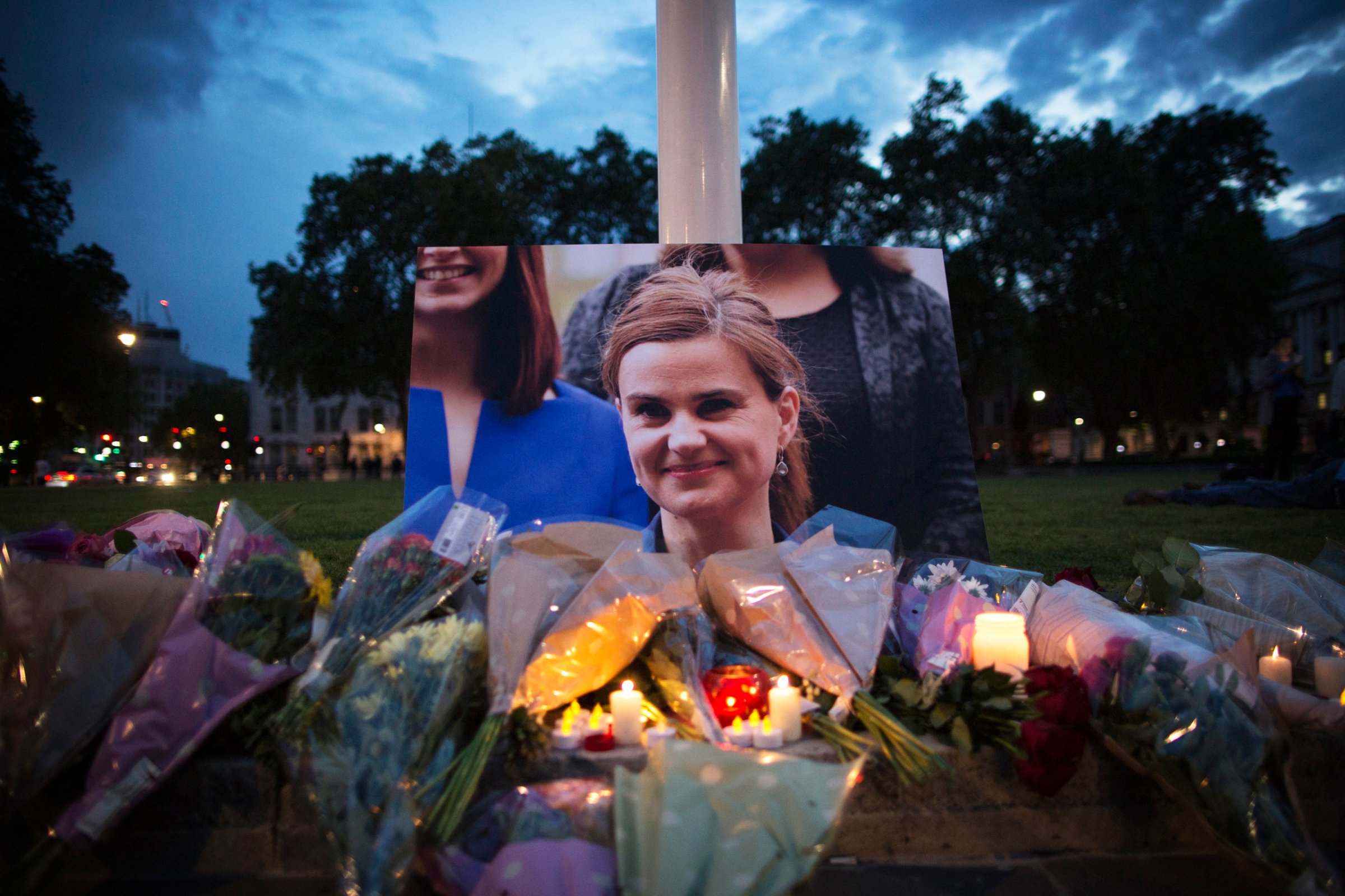 Flowers surround a picture of Jo Cox during a vigil in Parliament Square on June 16, 2016. The trial of the man suspected of killing Cox, Thomas Mair, started this week.