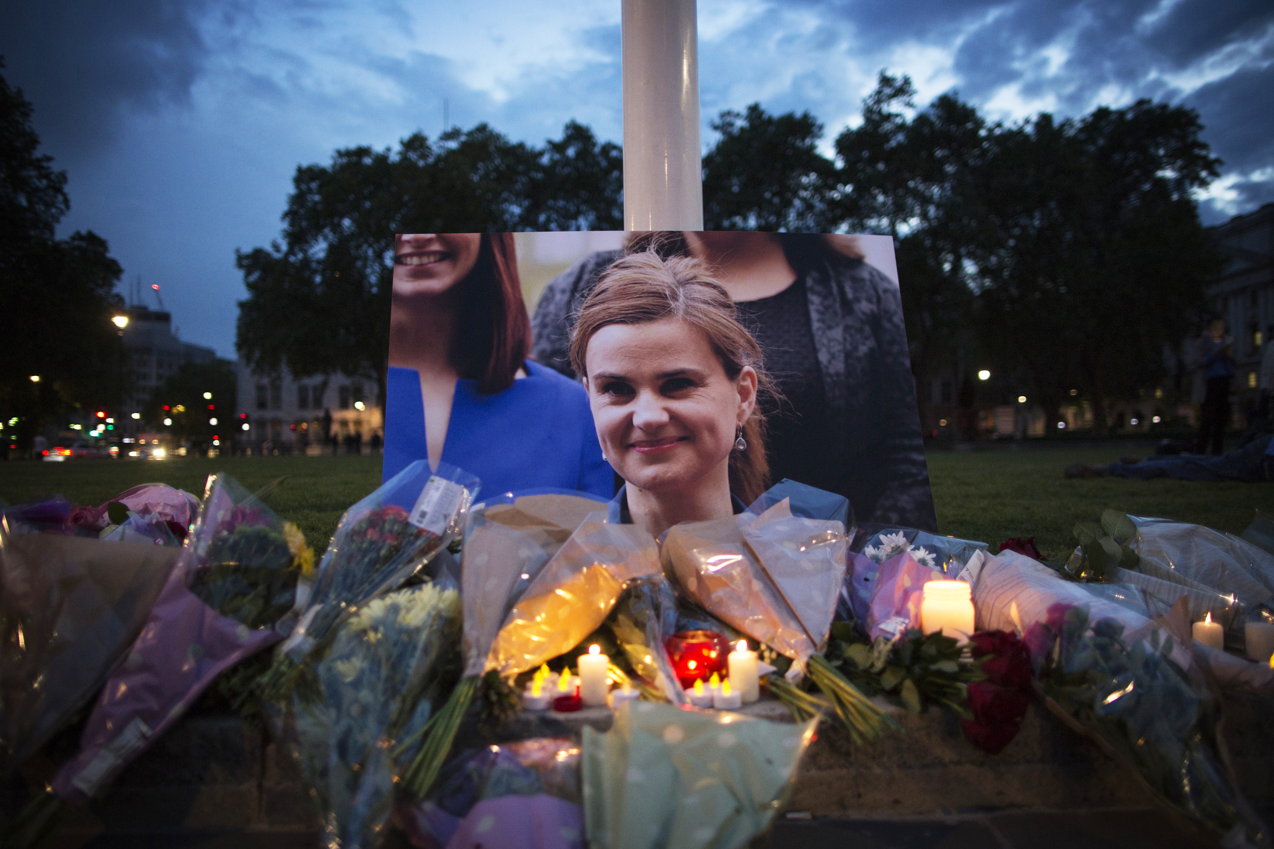 Flowers surround a picture of Jo Cox during a vigil in Parliament Square on June 16, 2016. The trial of the man suspected of killing Cox, Thomas Mair, started this week. (Dan Kitwood—Getty Images)