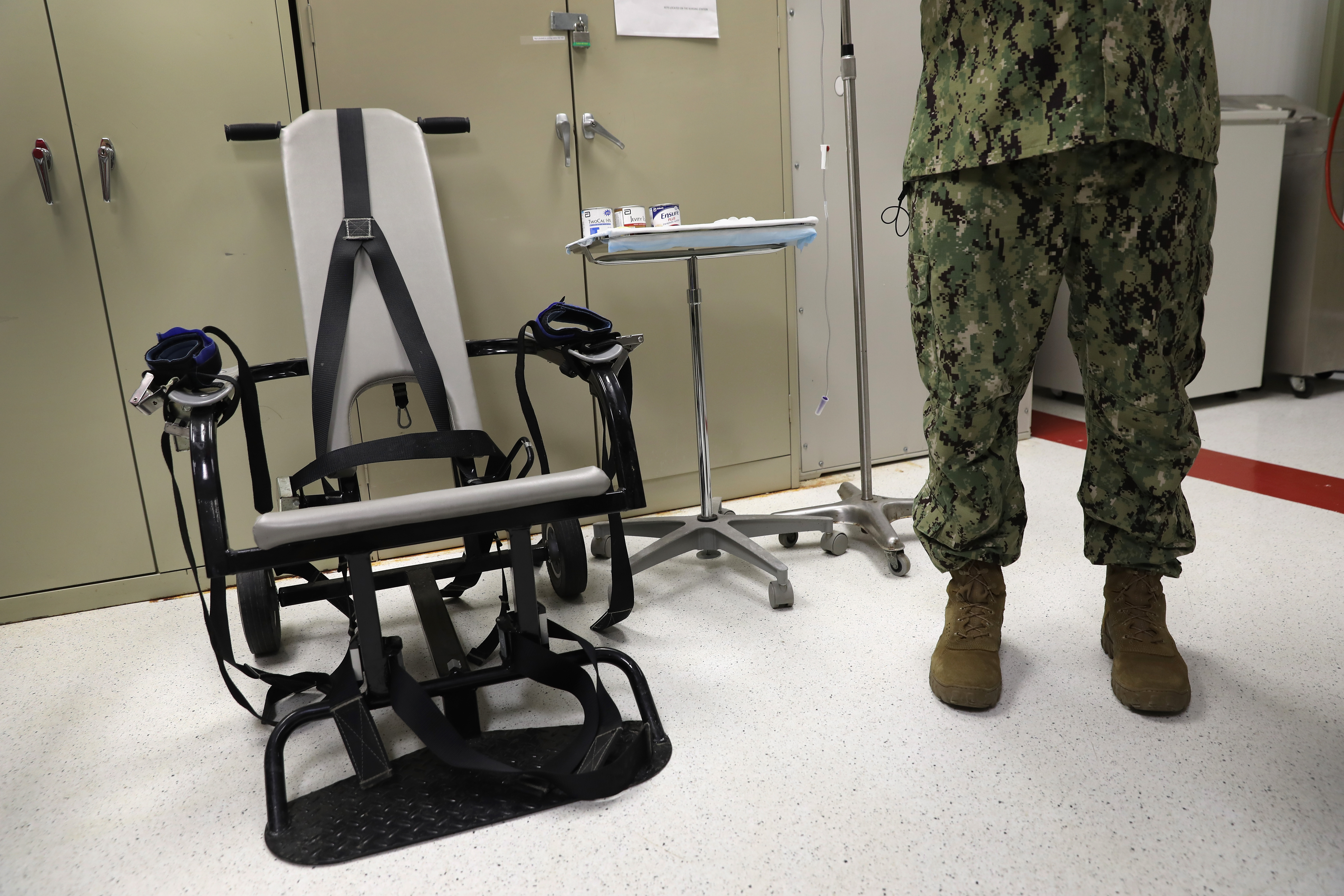 A U.S. Navy doctor stands near a restraint chair in the detainee clinic at Gitmo on Oct. 22, 2016.