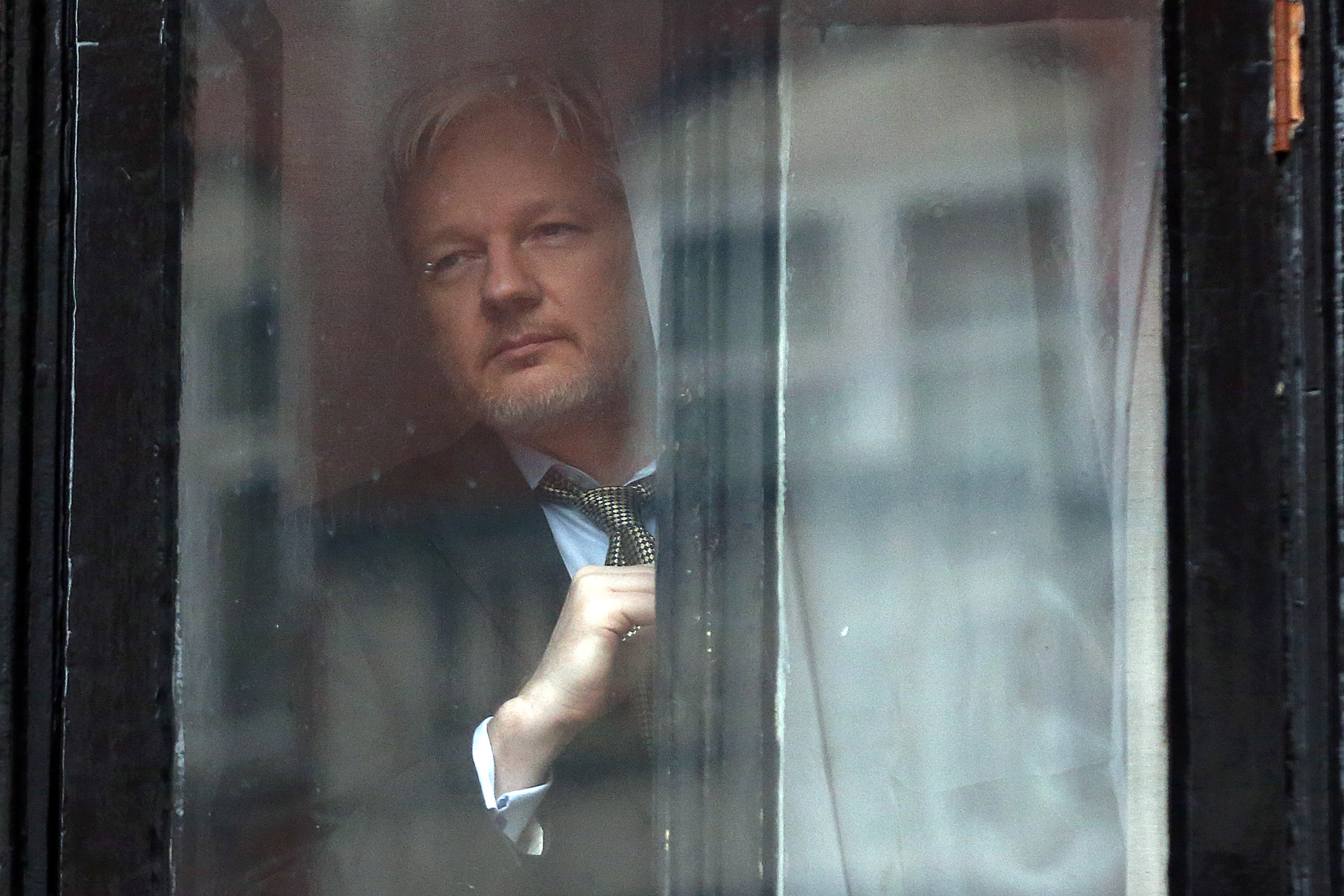 Wikileaks founder Julian Assange prepares to speak from the balcony of the Ecuadorian embassy where  he continues to seek asylum following an extradition request from Sweden in 2012, on February 5, 2016 in London, England.