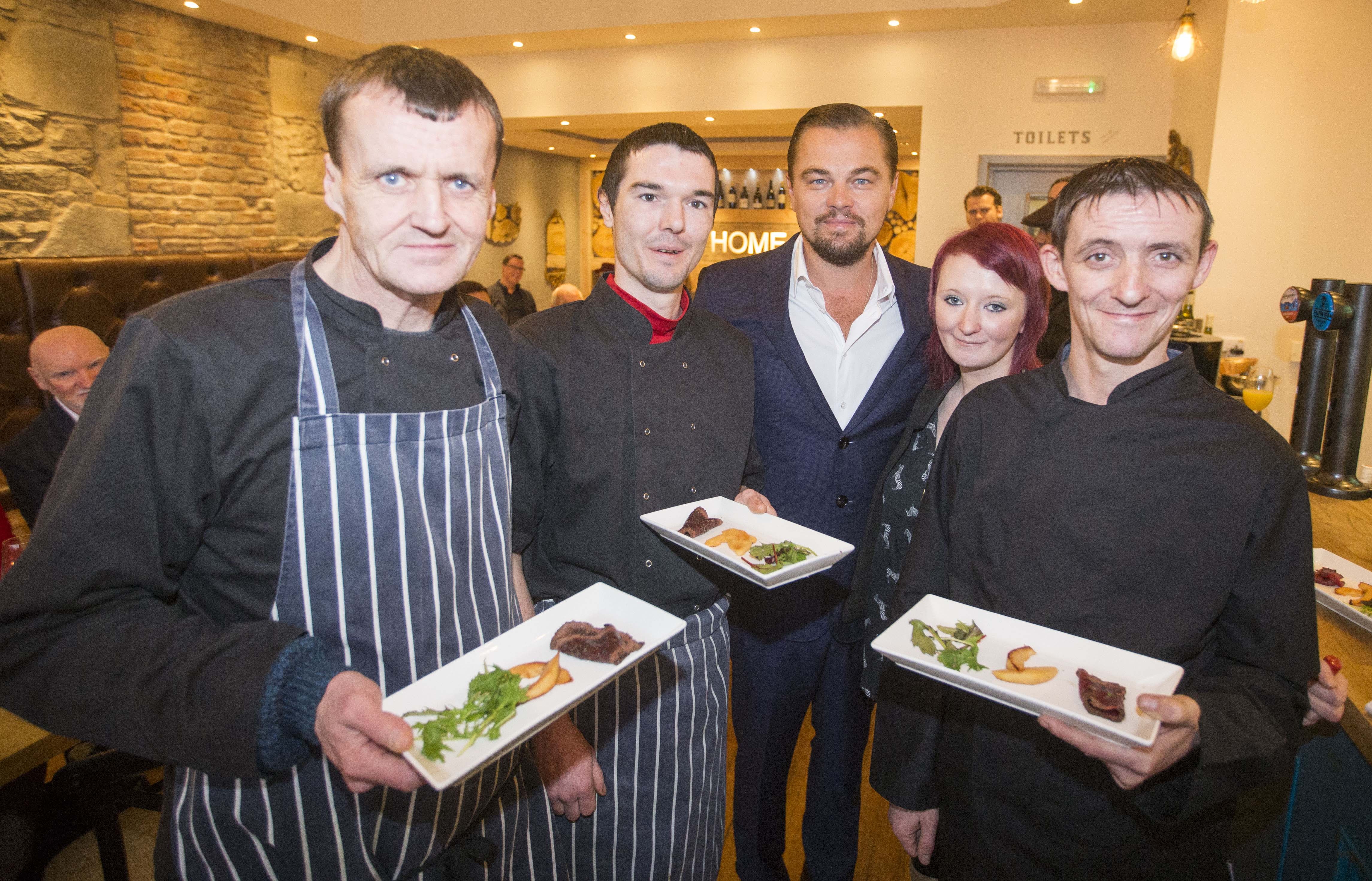 Hollywood actor Leonardo DiCaprio poses with formerly homeless staff (left to right) Colin Childs, Joe Hart, Biffy Mackay and Sonny Murray helped prepare lunch for DiCaprio and guests alongside acclaimed chef and Home co-founder Dean Gassabi (not pictured) at Social Bite restaurant, Home on November 17, 2016 in Edinburgh, Scotland. (Jeff Holmes&mdash;Getty Images)