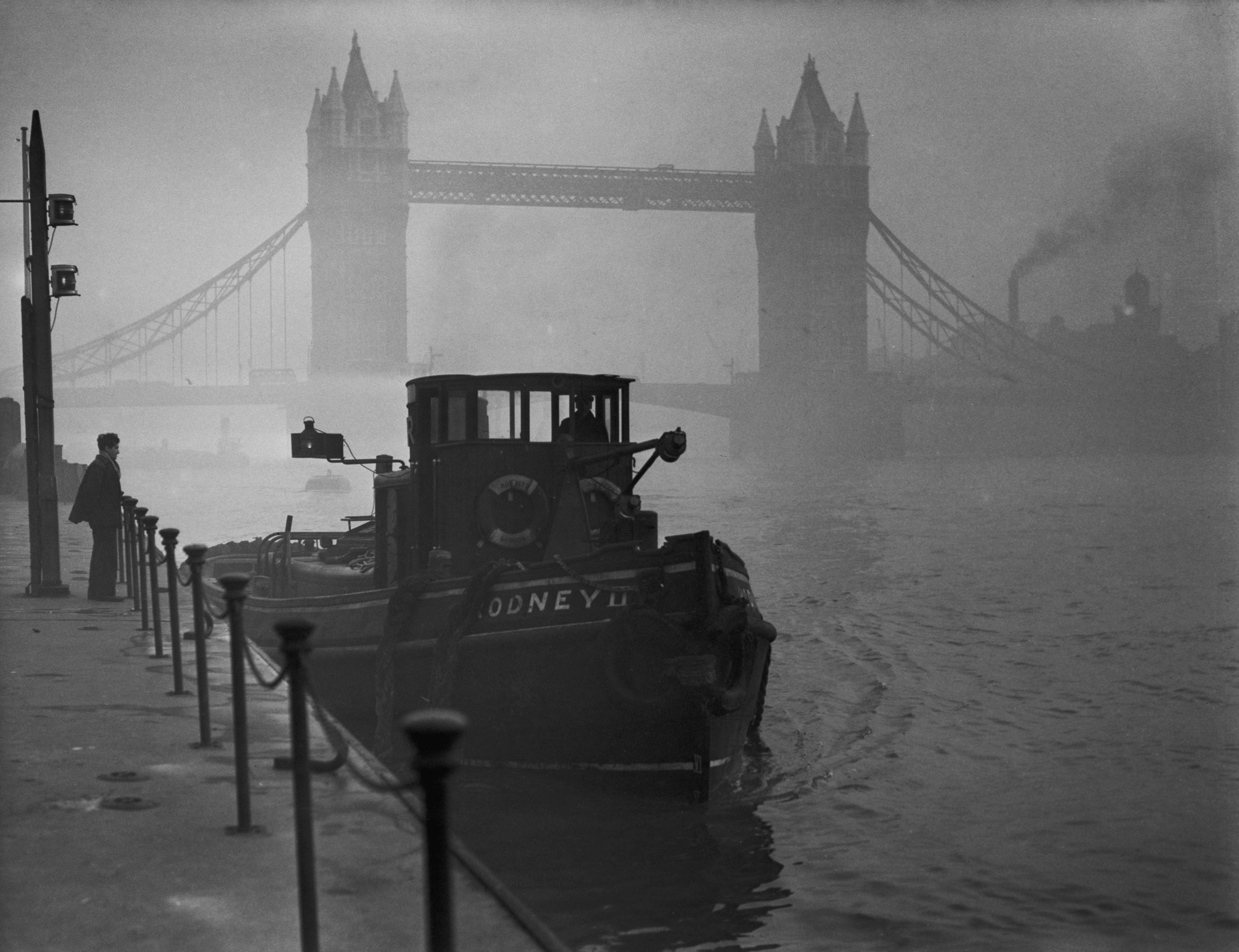A tugboat on the Thames near Tower Bridge in heavy smog, 1952. (Fox Photos—Getty Images)