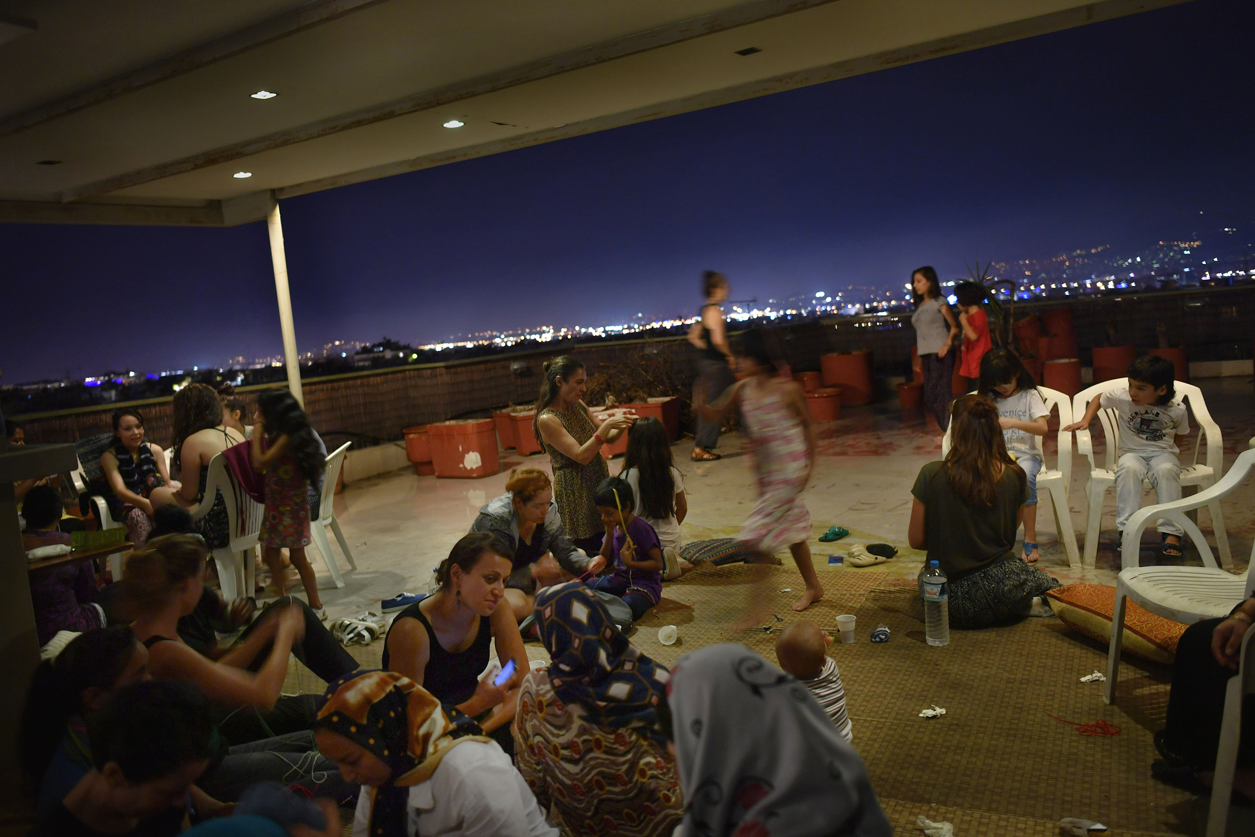 Refugee residents of the hotel organize a women-only dance party several nights a week on the rooftop terrace. It’s an opportunity for the women, many of them conservative Muslims from Syria, Iraq and Afghanistan, to relax, take off their headscarves and smoke hookah without worrying about prying male eyes. (Lynsey Addario—Getty Images Reportage for TIME)