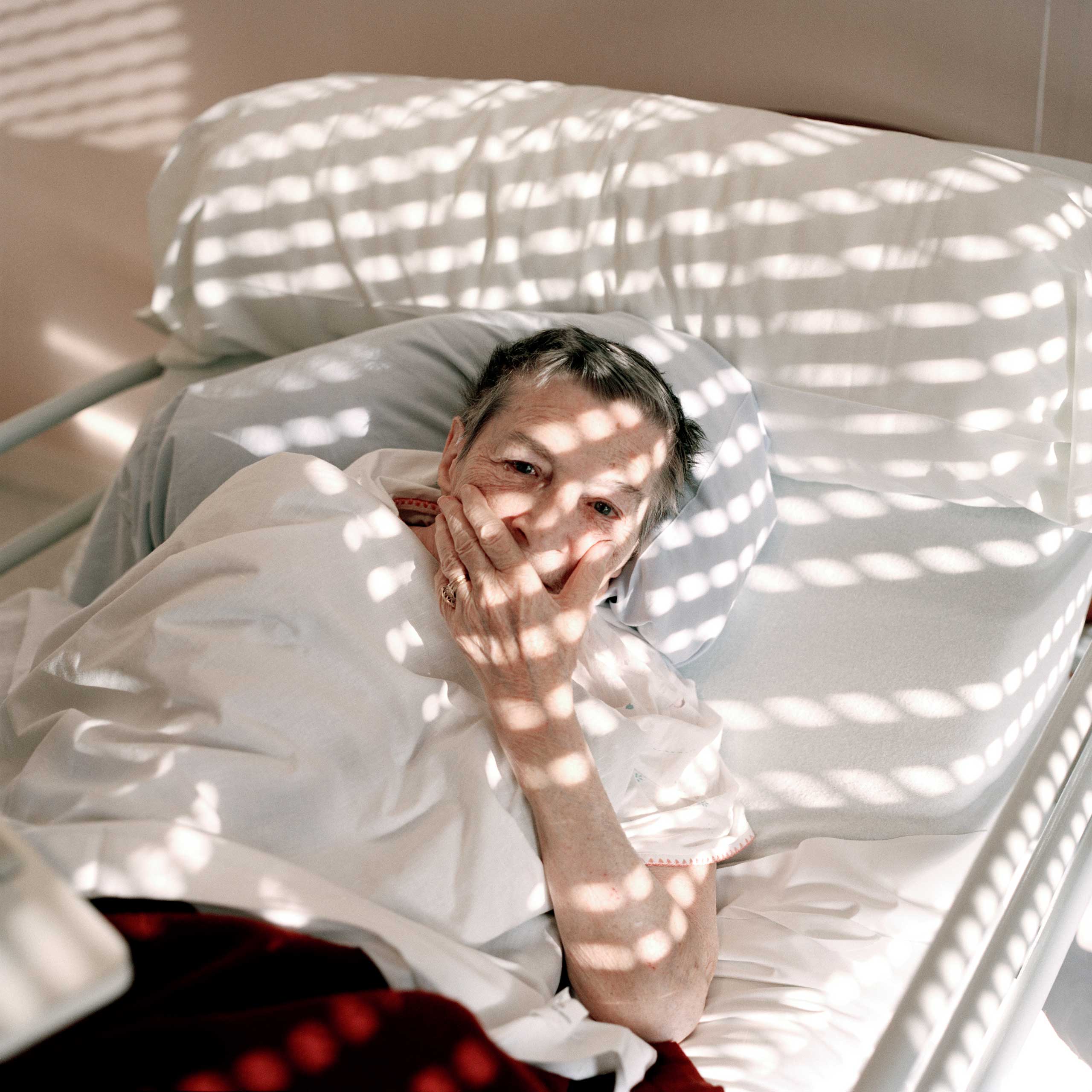 A resident lies in bed in the Alzheimer’s ward. Most residents in the ward have reached a state in which they have lost most of their communication skills and few even recognize family members
