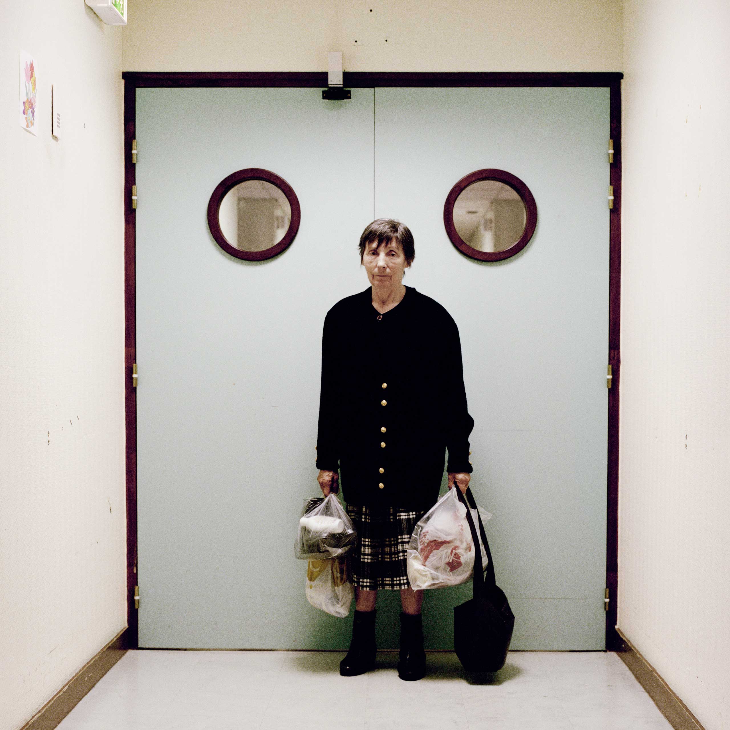 A resident stands in front of the ward’s locked exit door