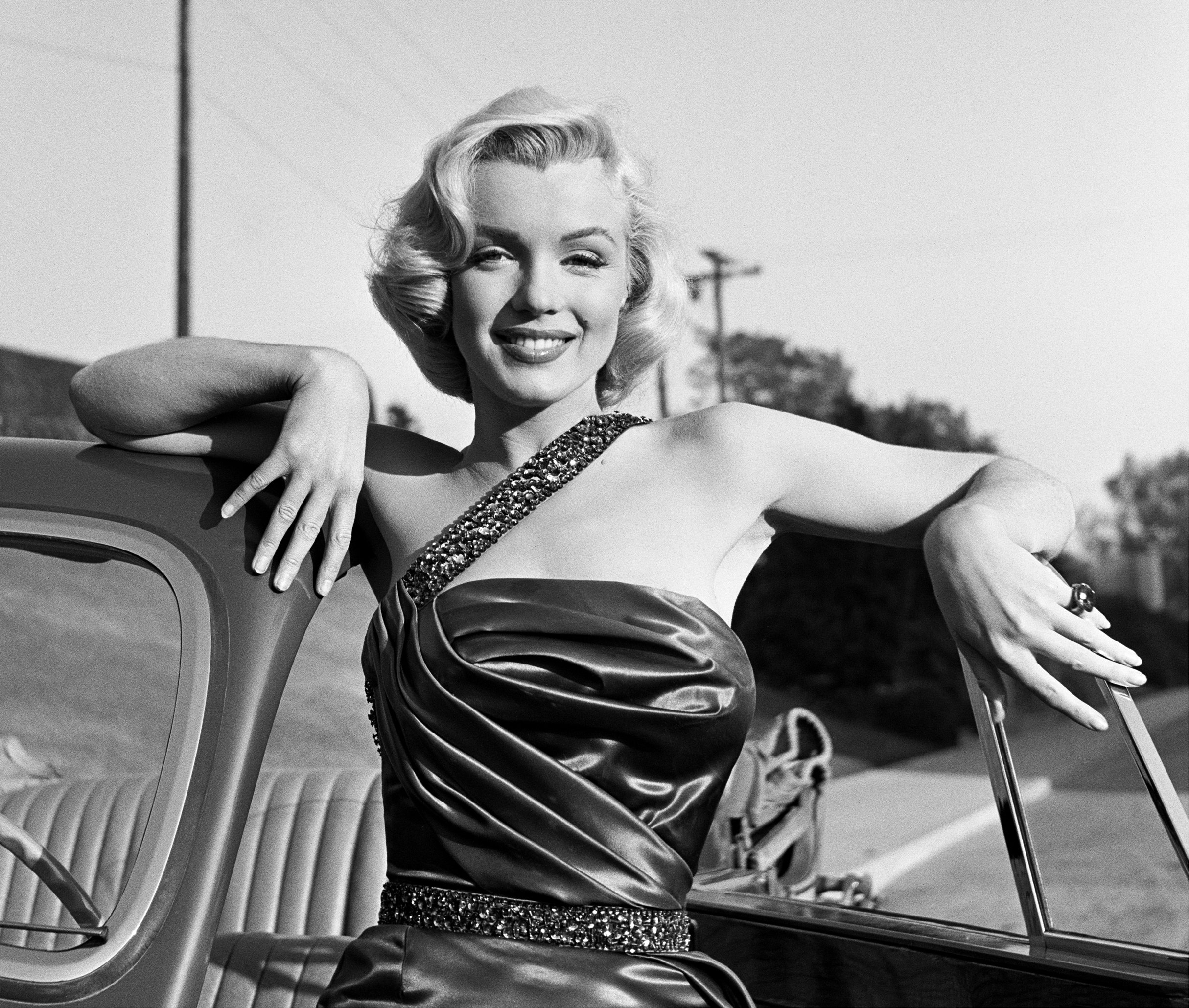 LOS ANGELES - 1953:  Actress Marilyn Monroe leans on a Singer Automobile as she poses for a portrait on the set of the movie "How To Marry A Millionaire" which was released in 1953. (Photo by Frank Worth, Courtesy of Capital Art/Getty Images) (Frank Worth, Courtesy of Capital Art/Getty Images)