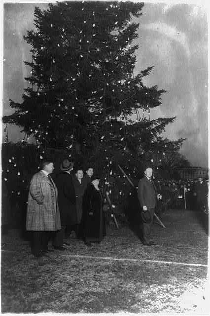 President Coolidge illuminating the community Christmas tree, which has been erected south of the White House. (Library of Congress)