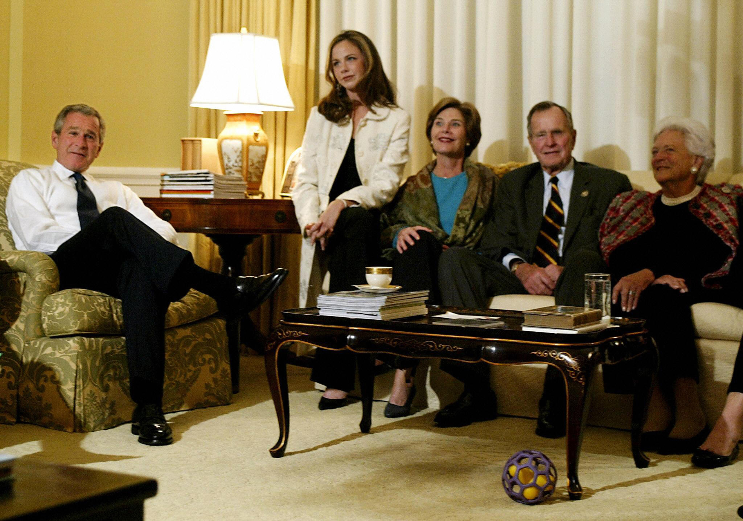 President-elect George W. Bush (L) and First Lady Laura Bush (C) are joined by daughter Barbara (2L), former U.S. president George H.W. Bush (2R) and his wife former first lady Barbara (R) watching the election retursn in the White House in November of 2004.