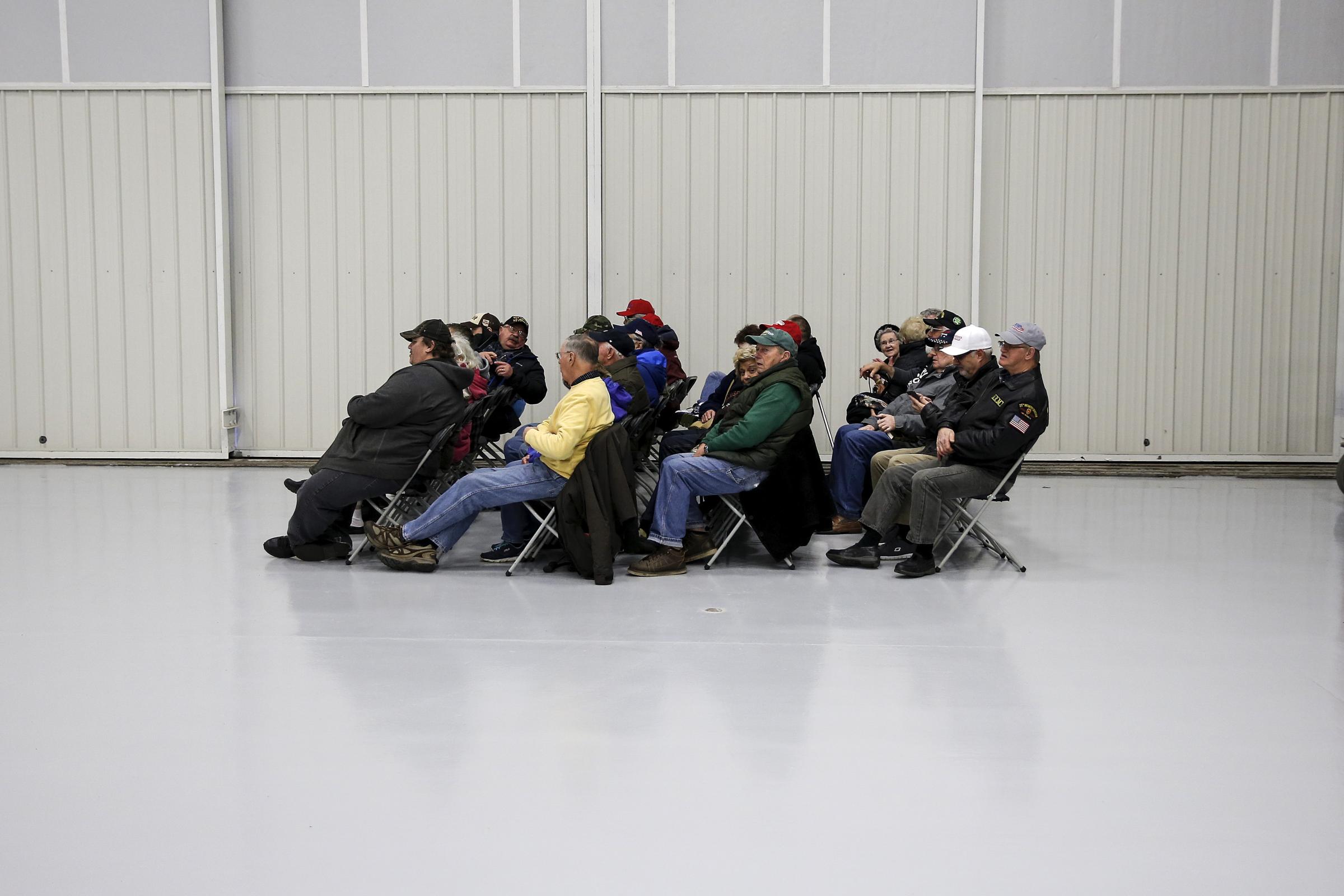 A group of people fill a seated area before U.S. Republican presidential candidate Donald Trump speaks at a campaign event in an airplane hangar in Rome, New York