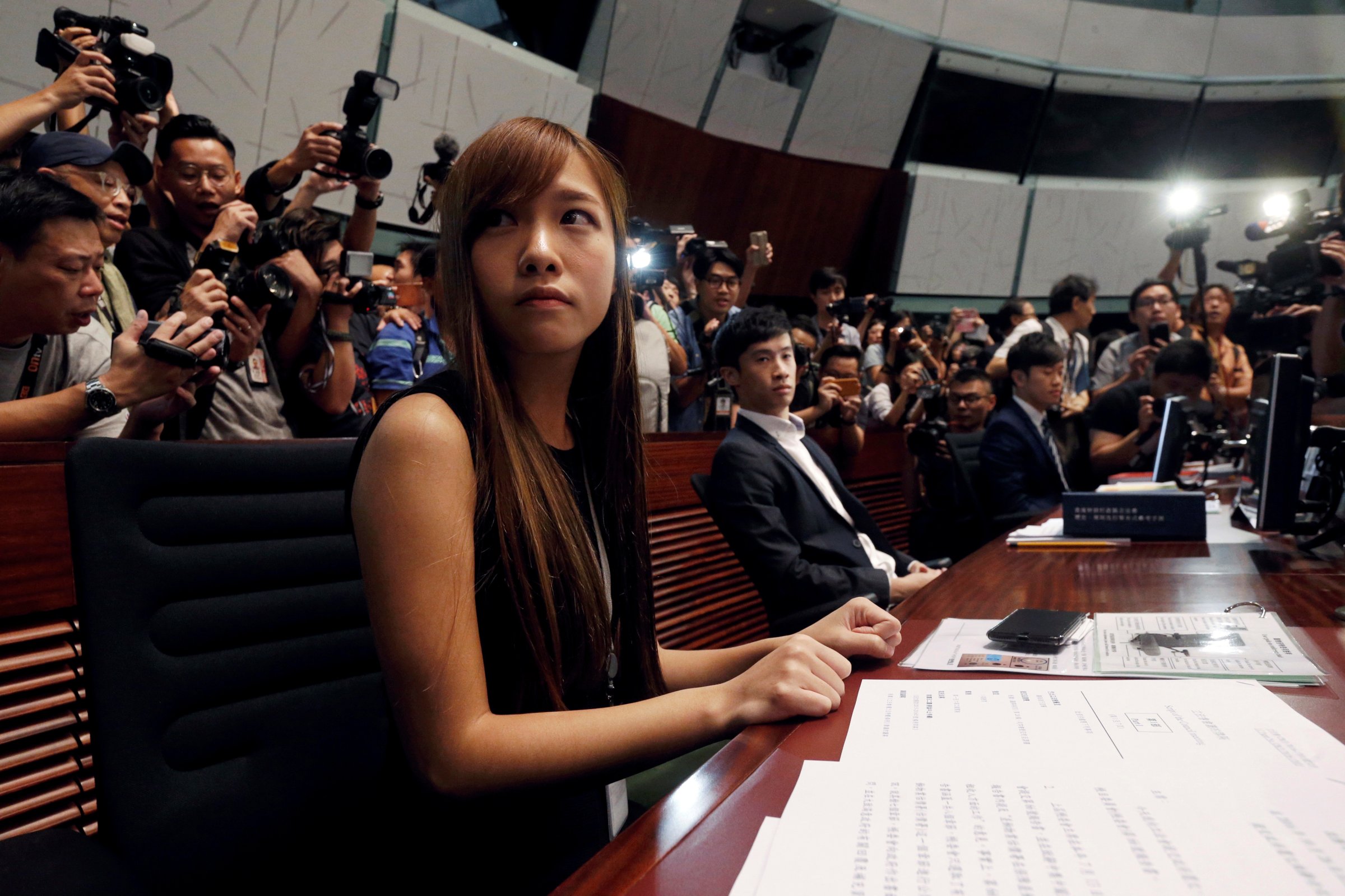 Pro-independence lawmakers Yau Wai-ching (L) and Baggio Leung sit during a demonstration at the Legislative Council in Hong Kong