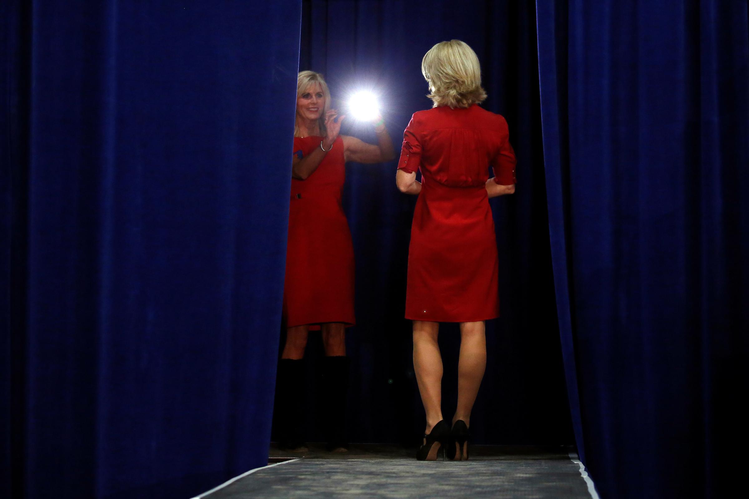 Two women take pictures on stage before Republican presidential nominee Donald Trump attends a campaign event in Springfield,