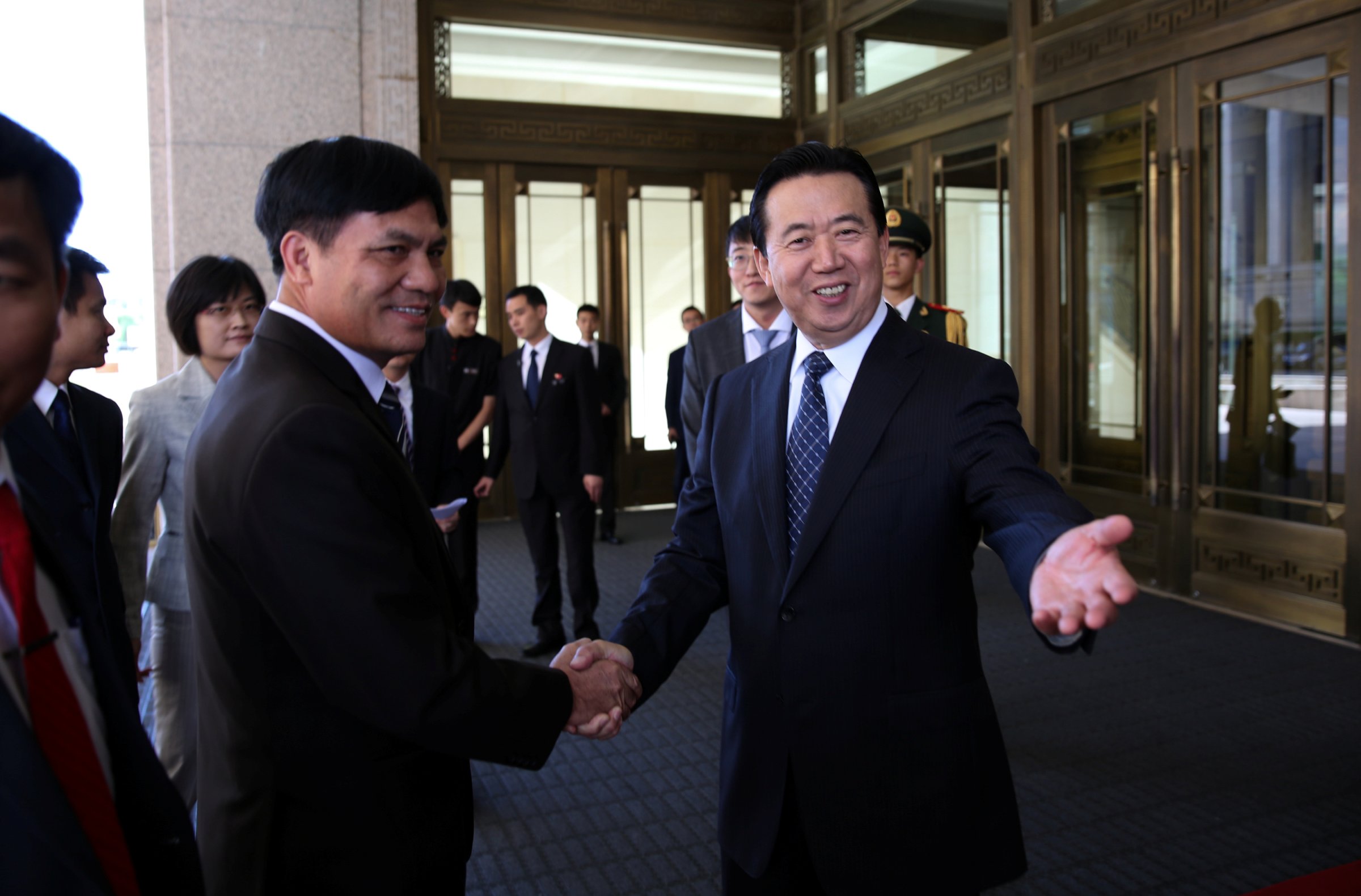 Meng Hongwei, Chinese Vice Public Security Minister, shakes hands with Nguyen Quang Dam, the commandant of the Vietnam Coast Guard, in Beijing
