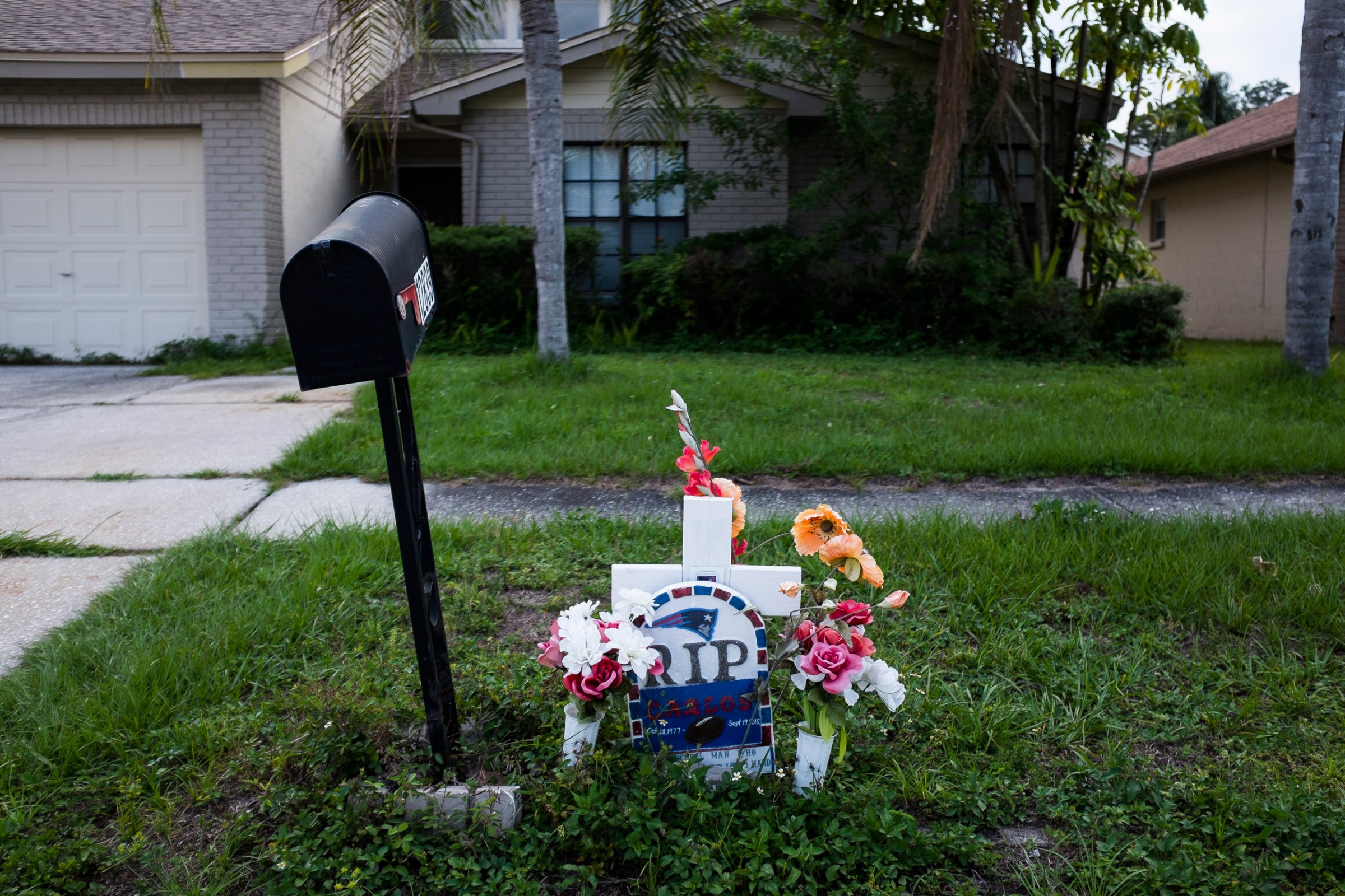 This Sept. 15, 2016 photo shows a memorial for Carlos Garica which has sat outside Yaileen Ayala's home for the last year. It marks where her ex-husband died after he was shot following an argument with a neighbor. (Zack Wittman/The Tampa Bay Times via AP)